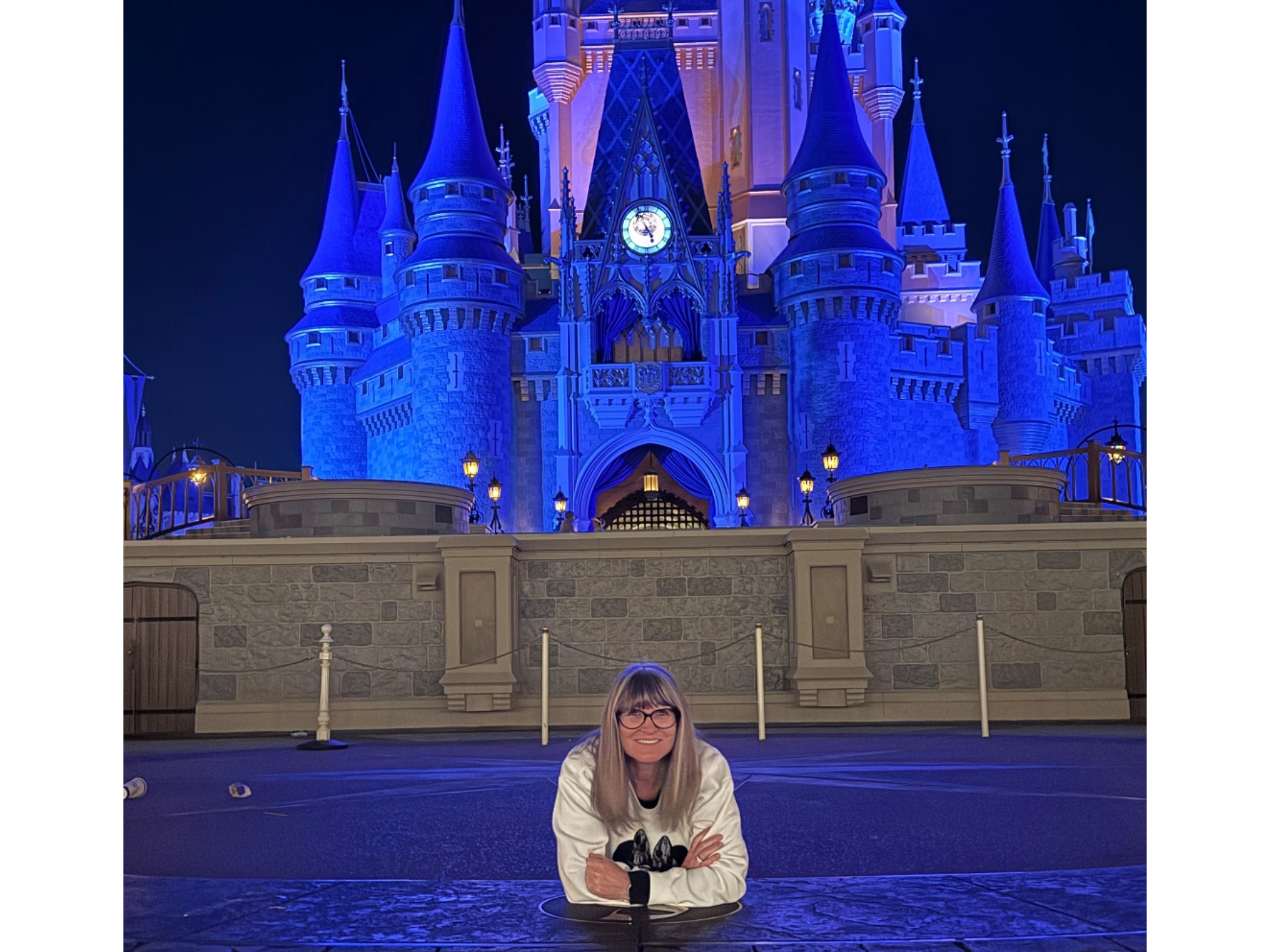 Laura lying in front of Cinderella Castle in Magic Kingdom at Walt Disney World Resort