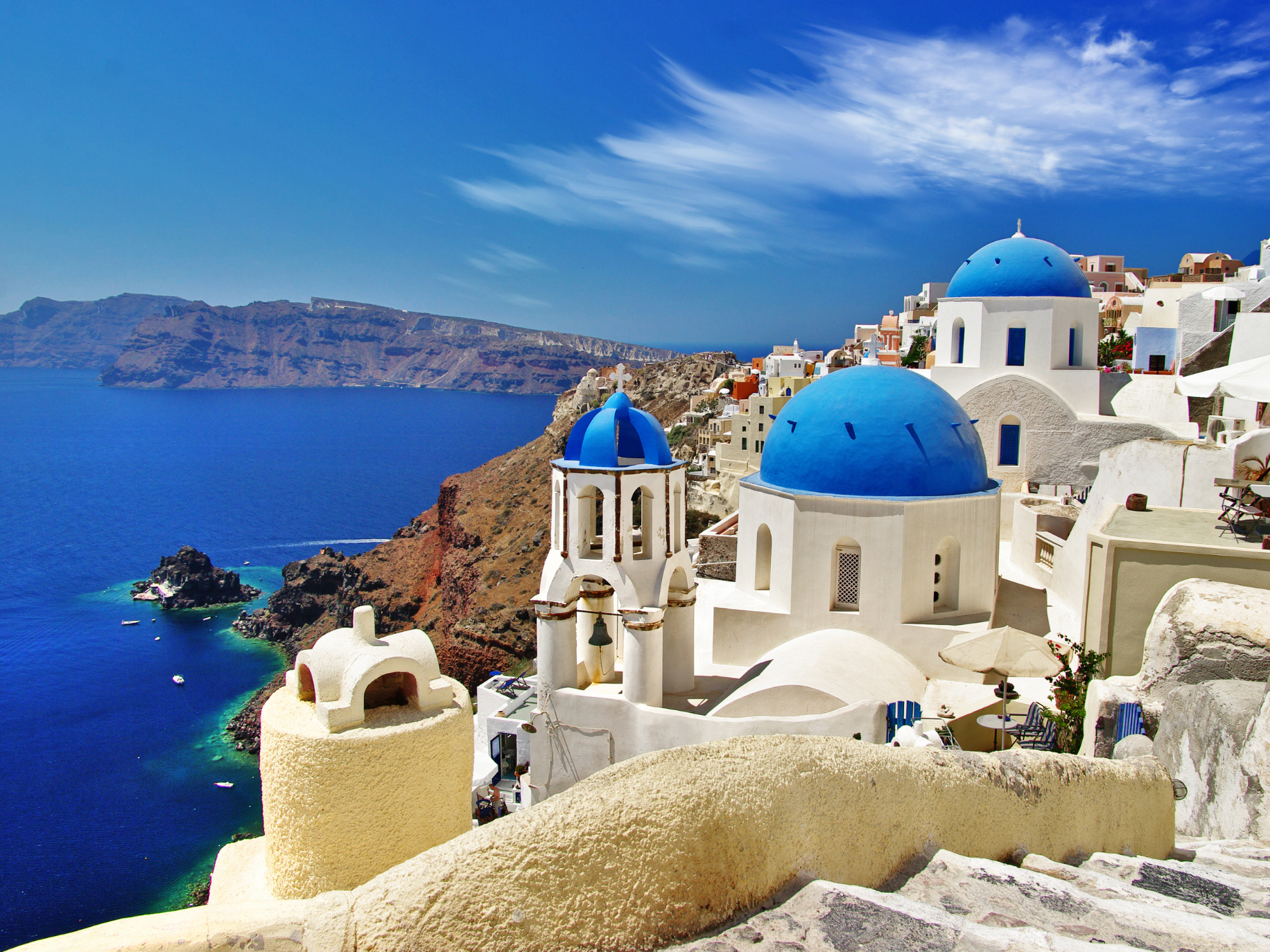 White and blue buildings overlooking caldera in Santorini