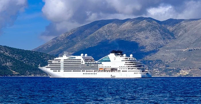 seabourn ship on the water with mountains in the background