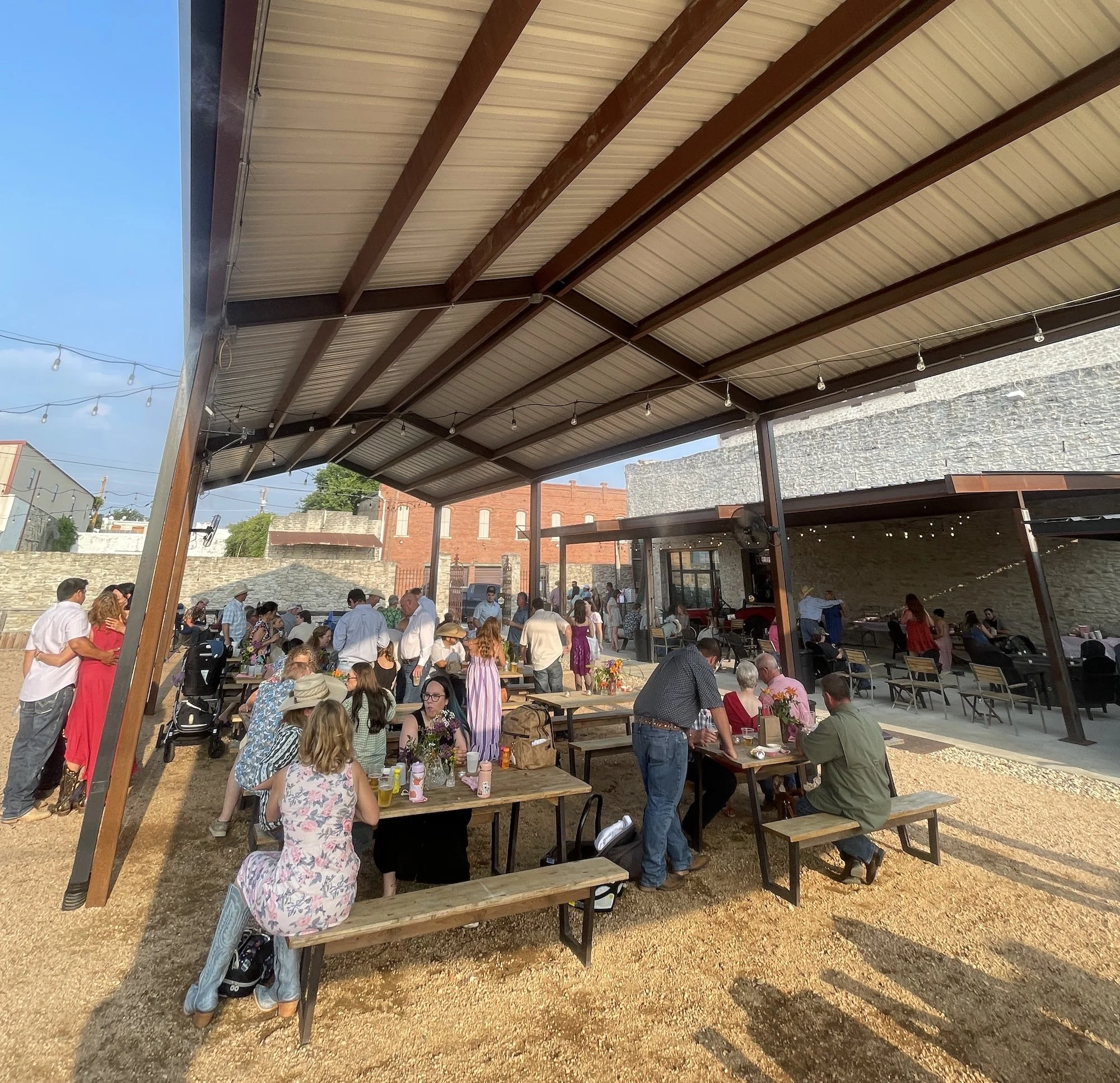 people sitting under a covered patio in hico