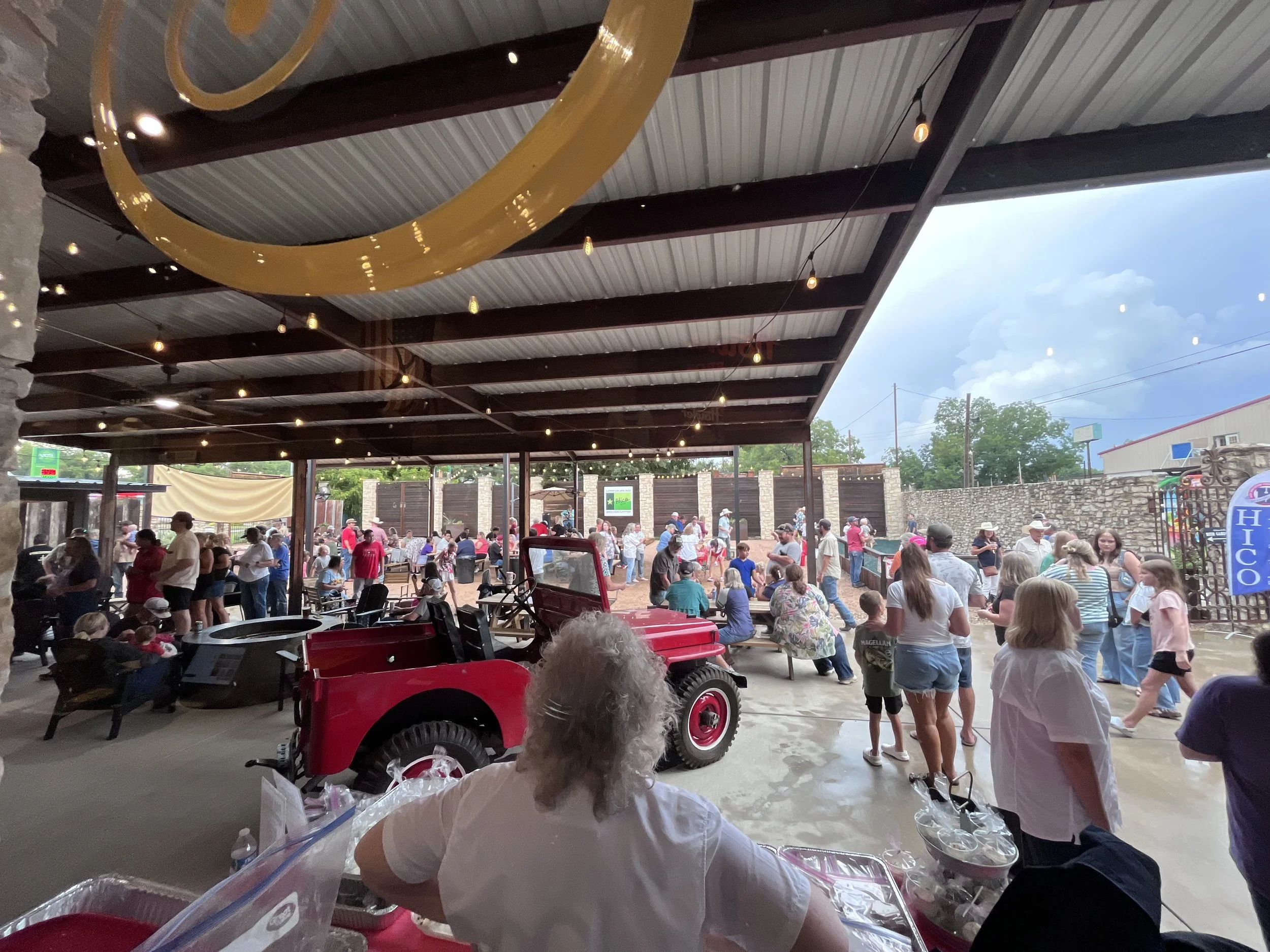 Guests gathered in the covered Green Canoe event space in Hico