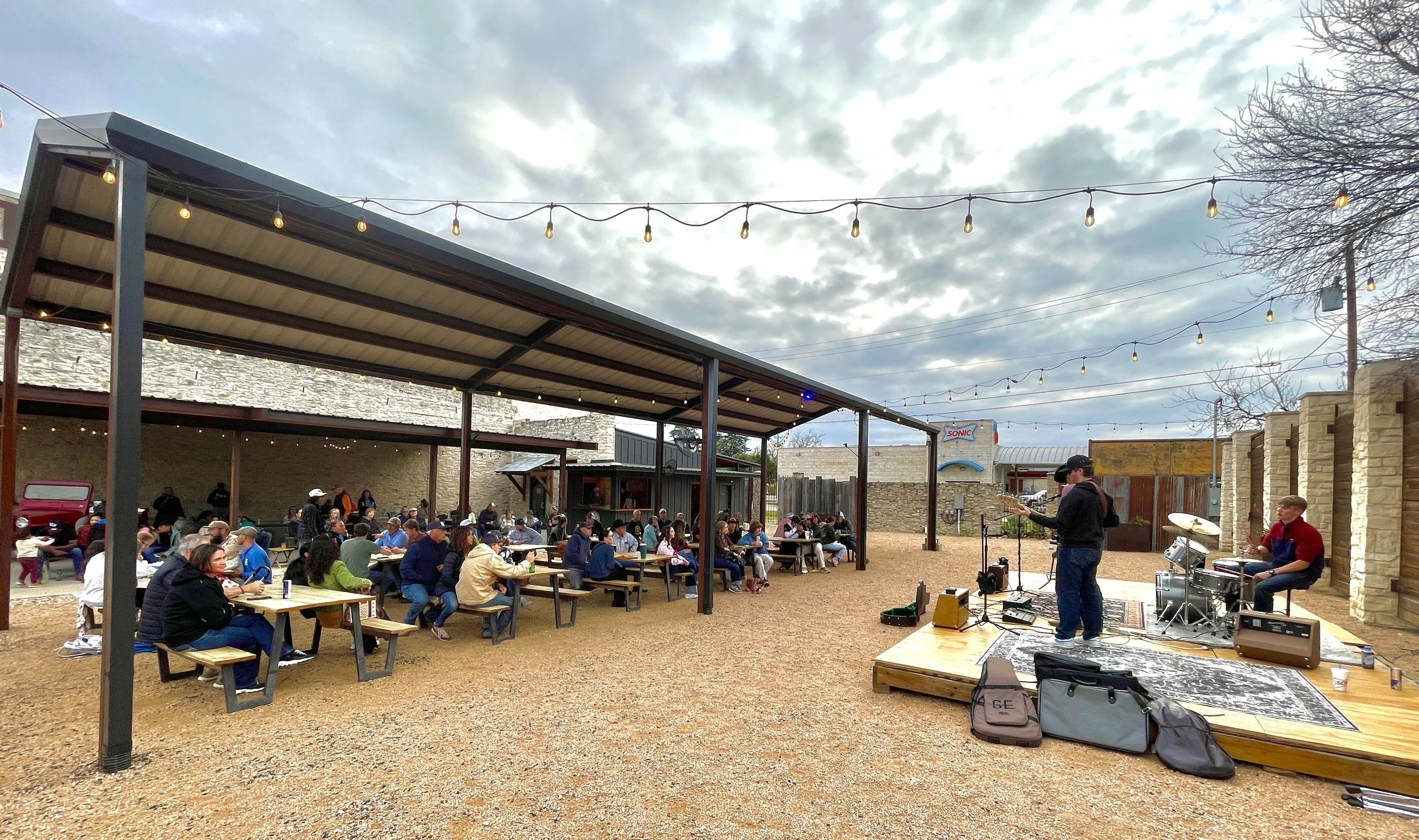guests listening to live music under a covered patio