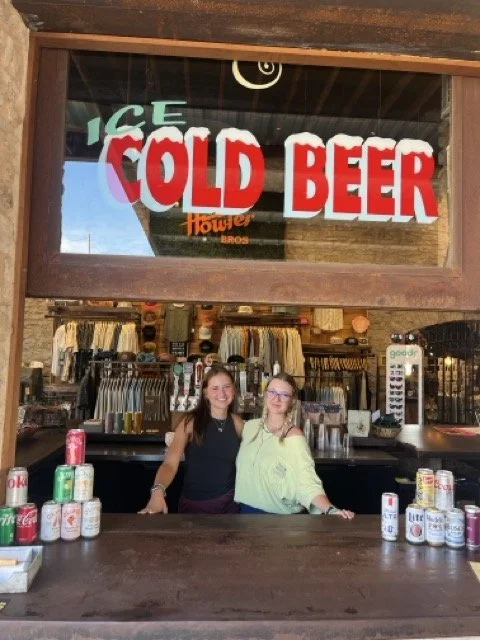 bartenders standing at bar window green canoe