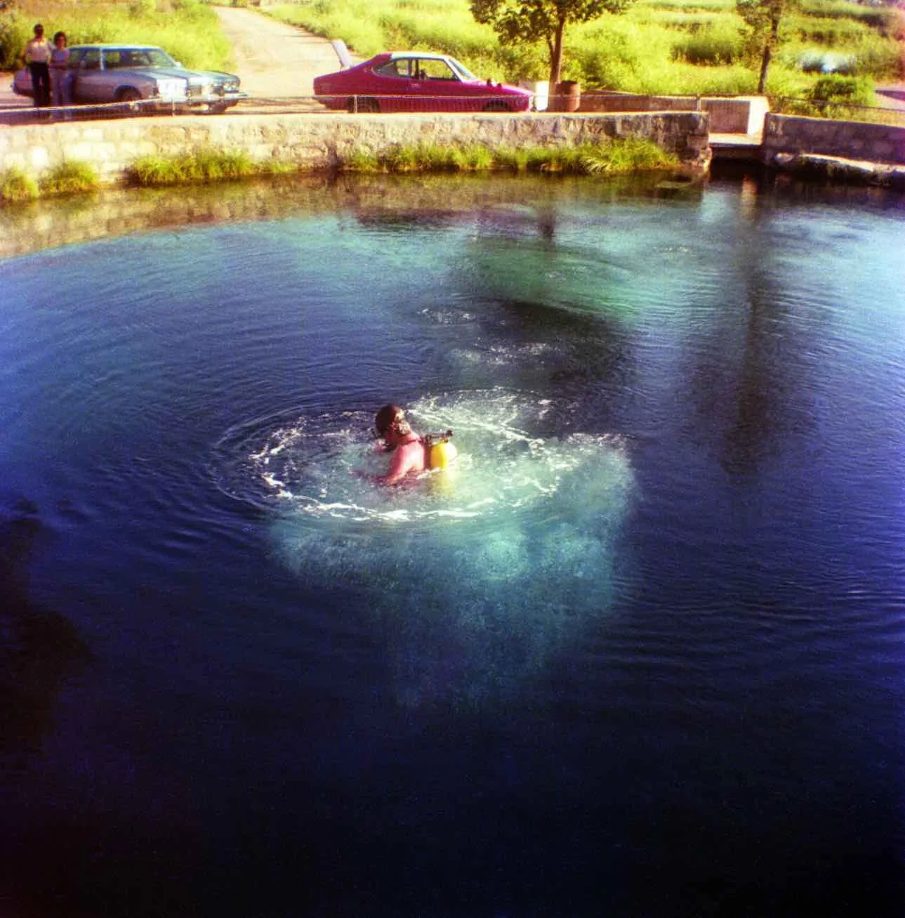 After photo restoration image showing enhanced color and clarity in a photo of a person swimming.