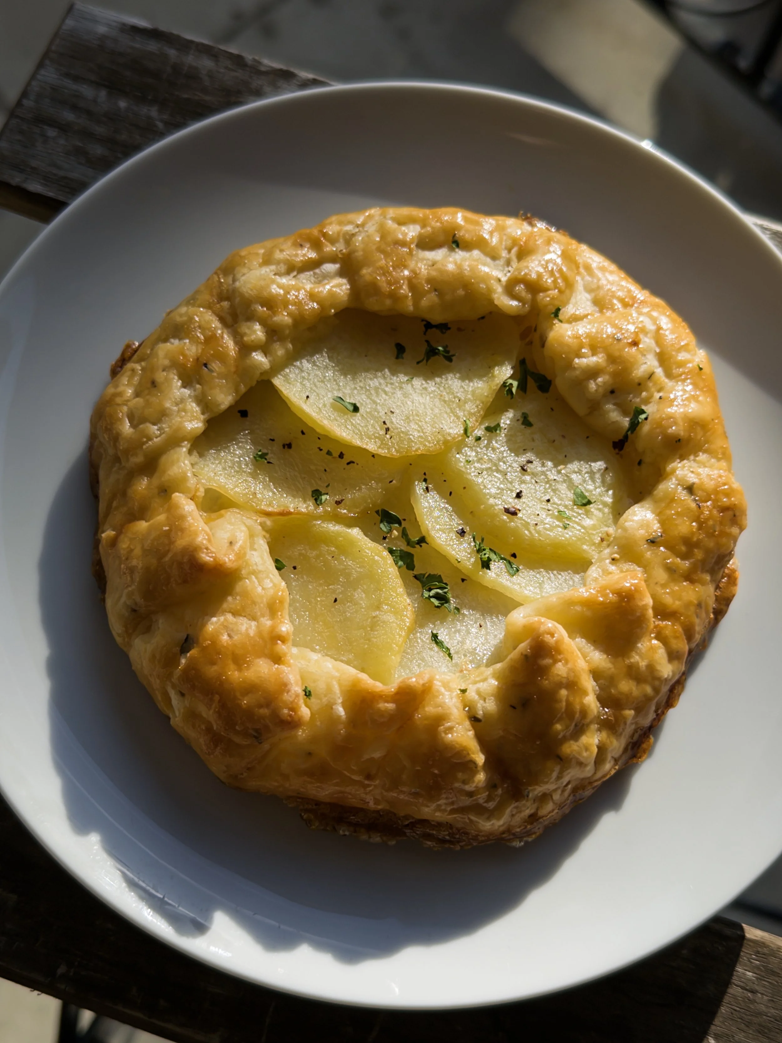 Potato and cheese croissant in white bowl on wooden table