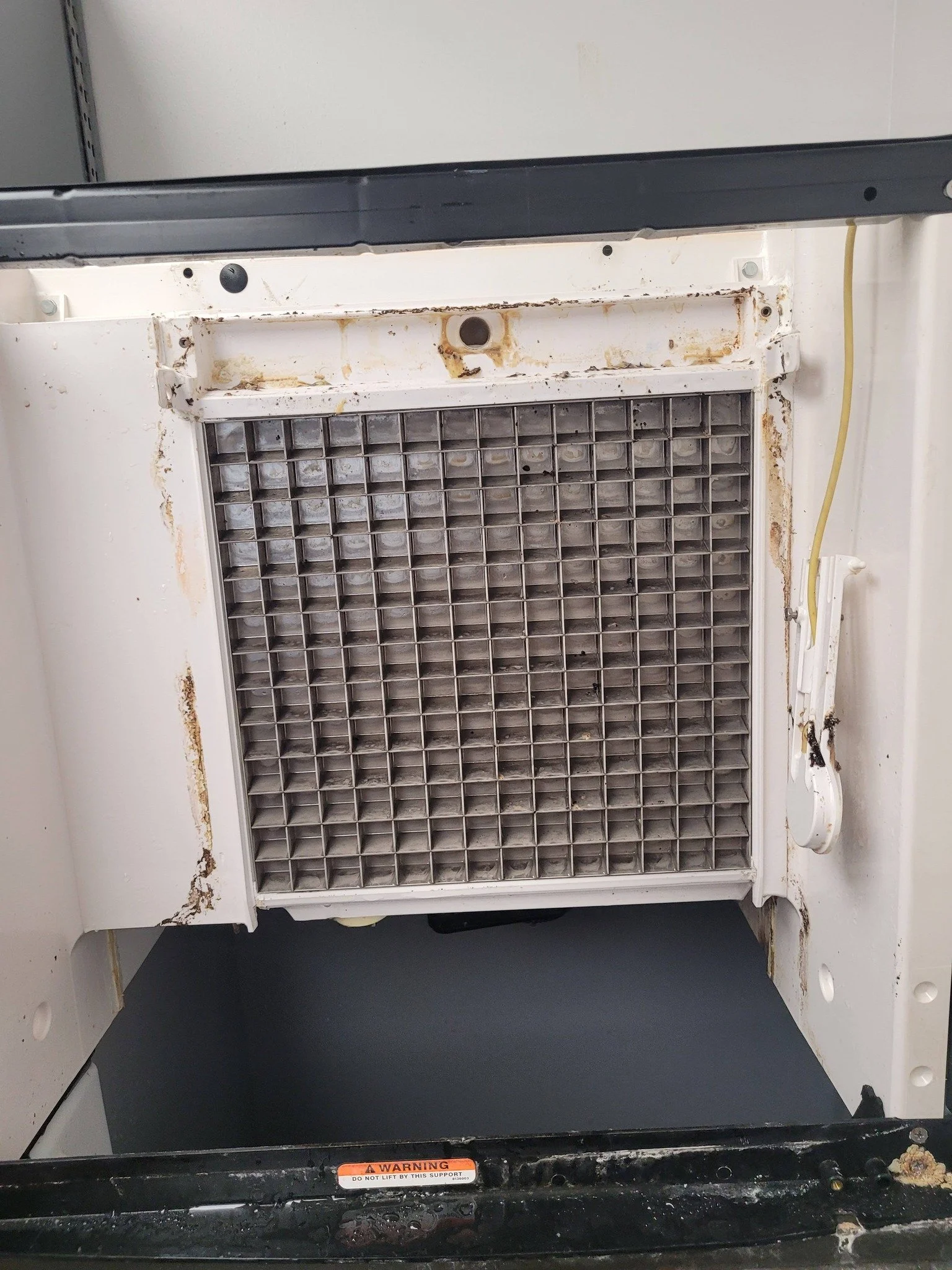 Before and after comparison of a commercial ice machine showing heavy buildup removed and surfaces fully cleaned and sanitized.