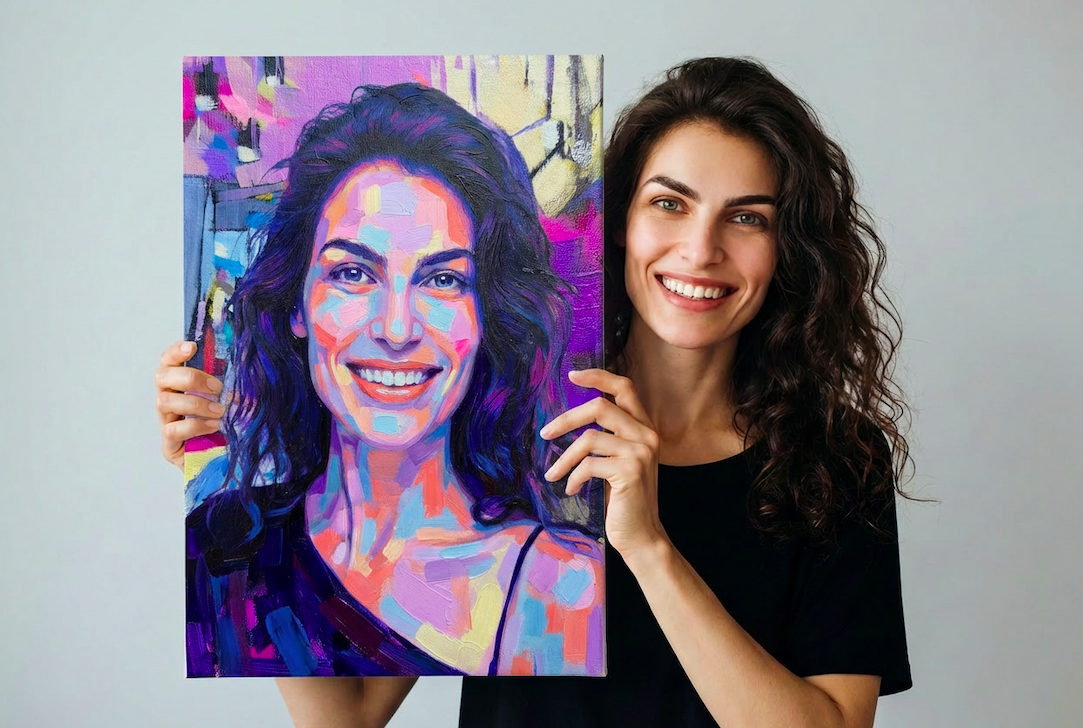 Woman with curly dark hair smiling and holding a colorful portrait painting of herself.