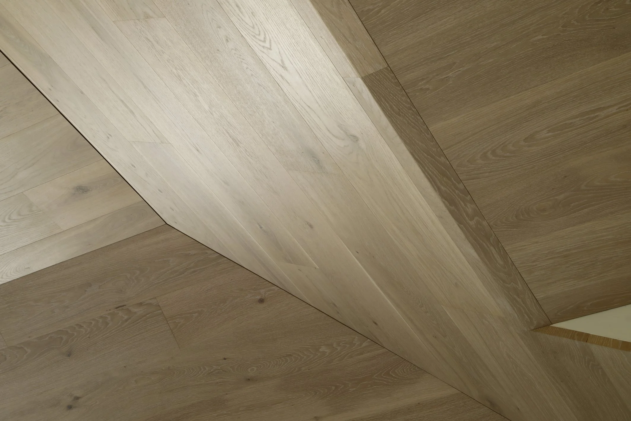 Close-up of a wooden corner with light and dark wood panels meeting at a right angle.
