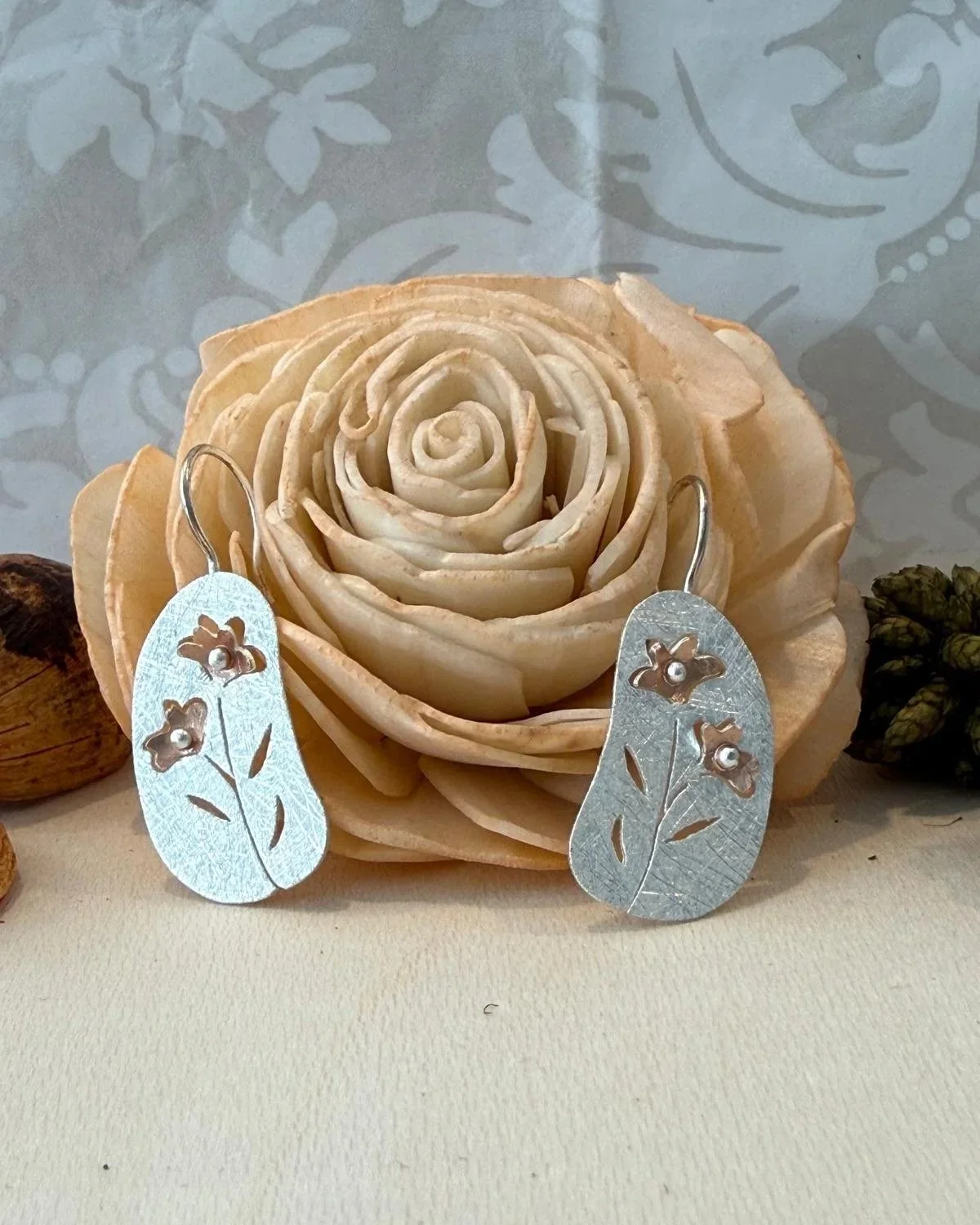 silver & rose gold plated 25 x 13mm disc with flower cut out drop earrings