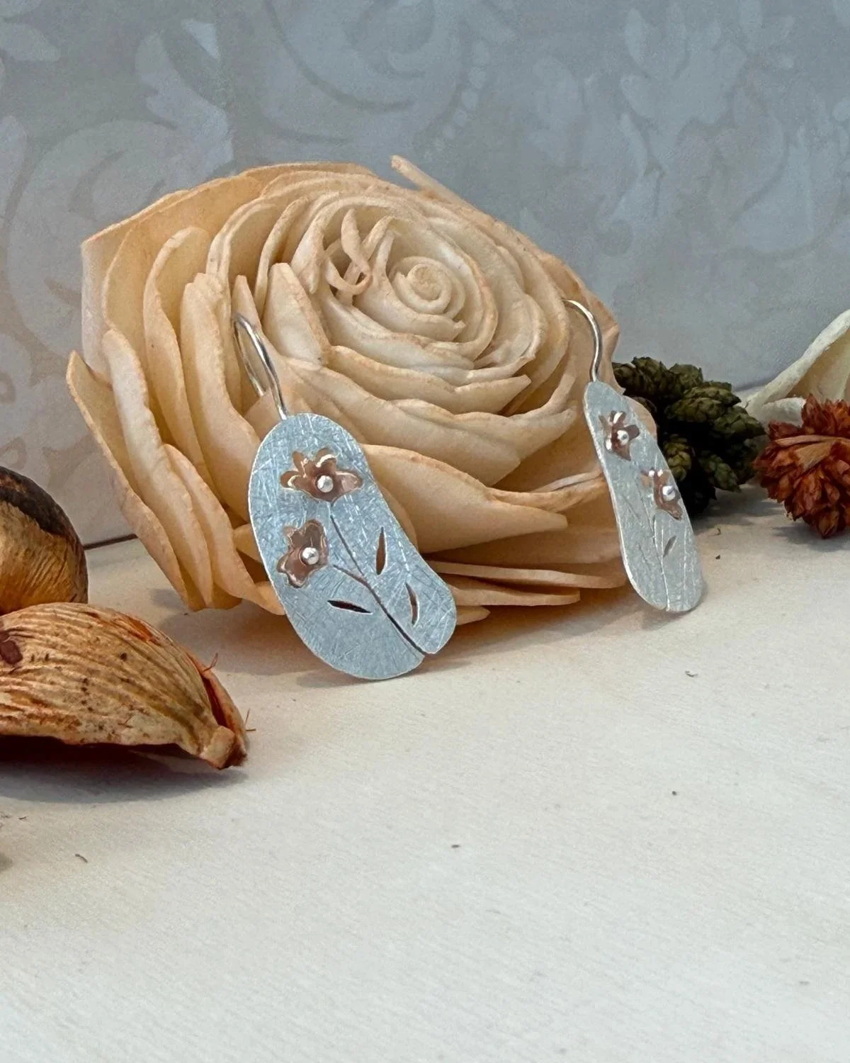 silver & rose gold plated 25 x 13mm disc with flower cut out drop earrings