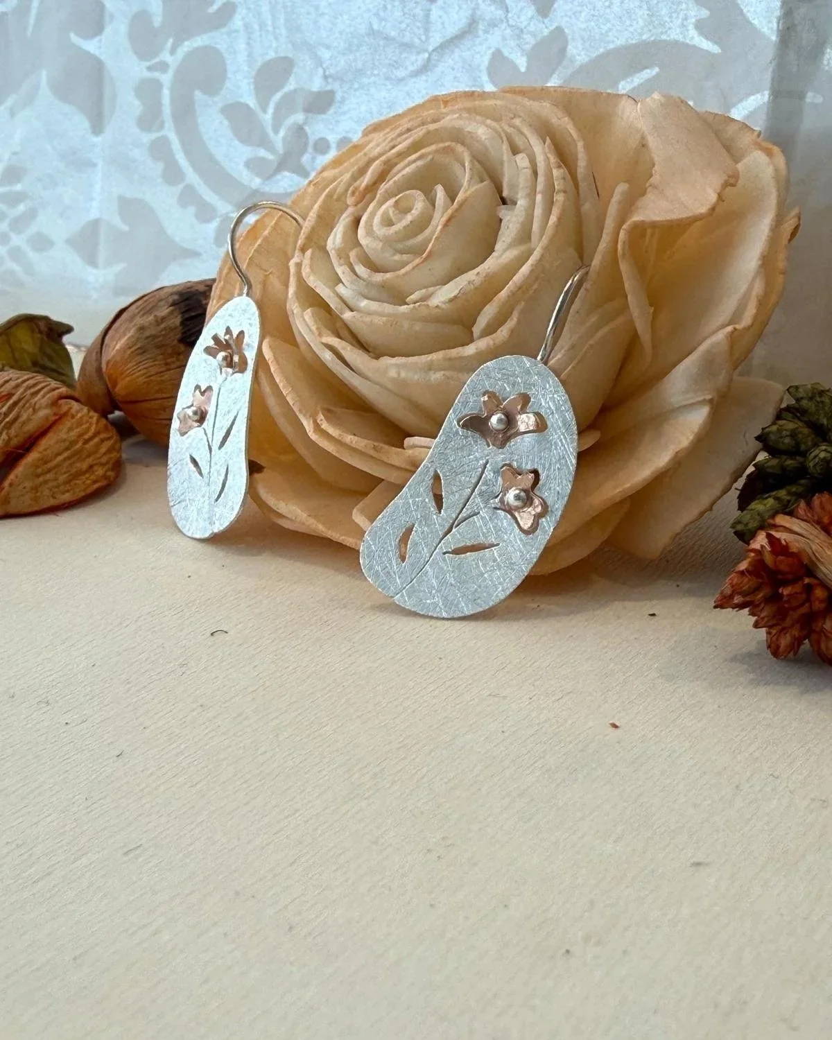 silver & rose gold plated 25 x 13mm disc with flower cut out drop earrings