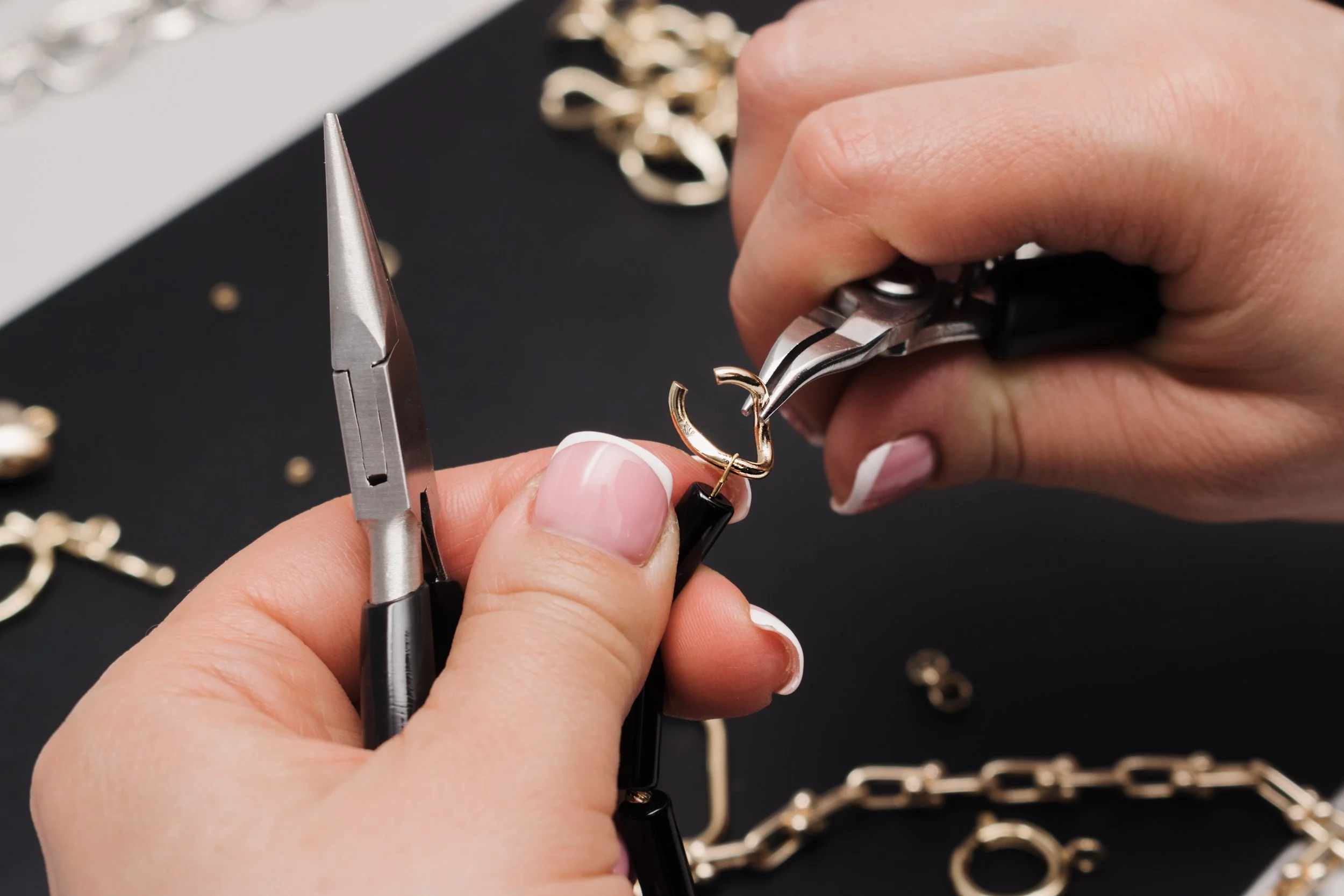 hands-crafting-jewelry-with-pliers-on-dark-surface-2026-01-07-06-32-59-utc.jpg