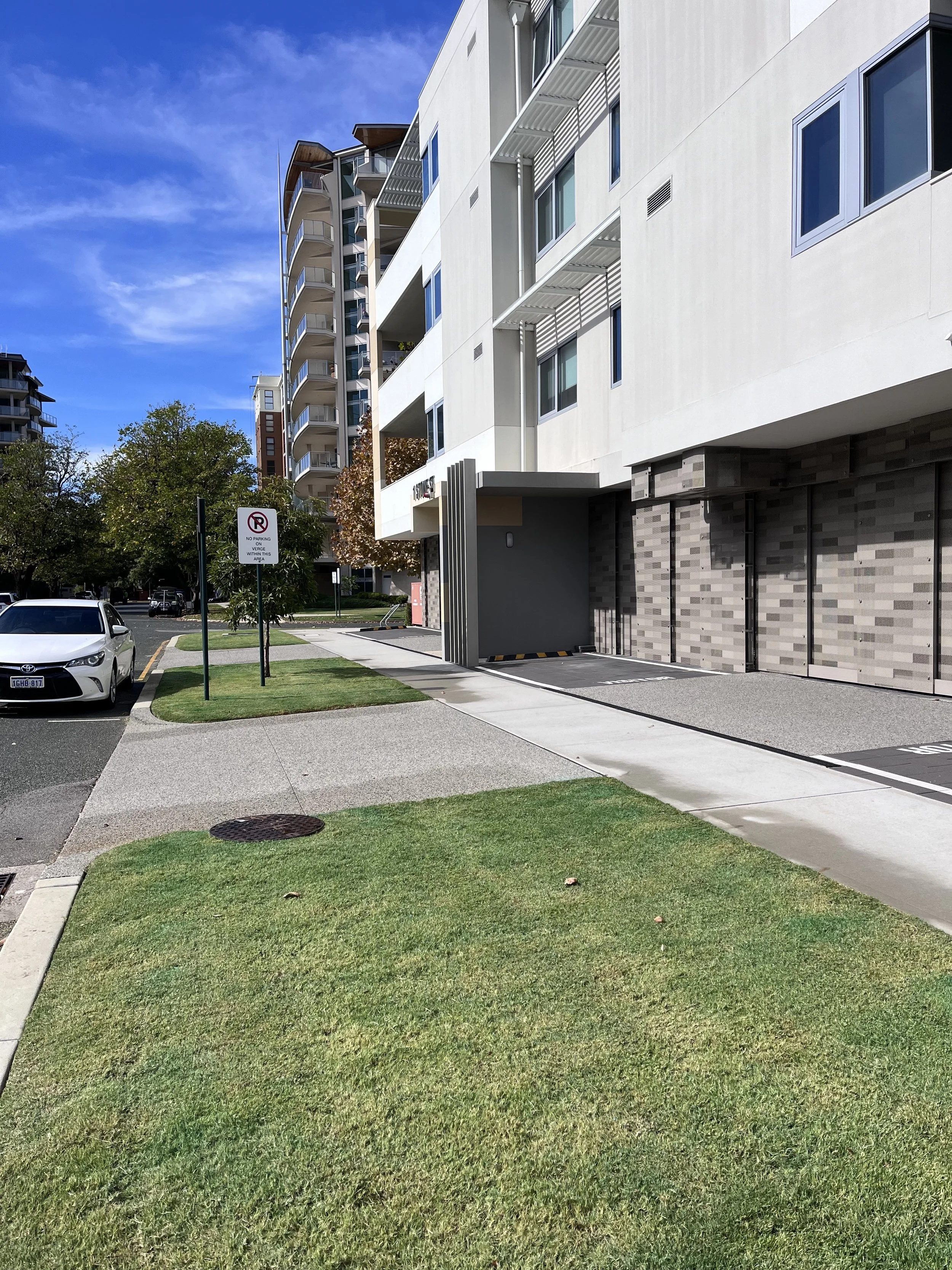 Mountain landscape with snow-capped peaks and a modern building on a hillside.