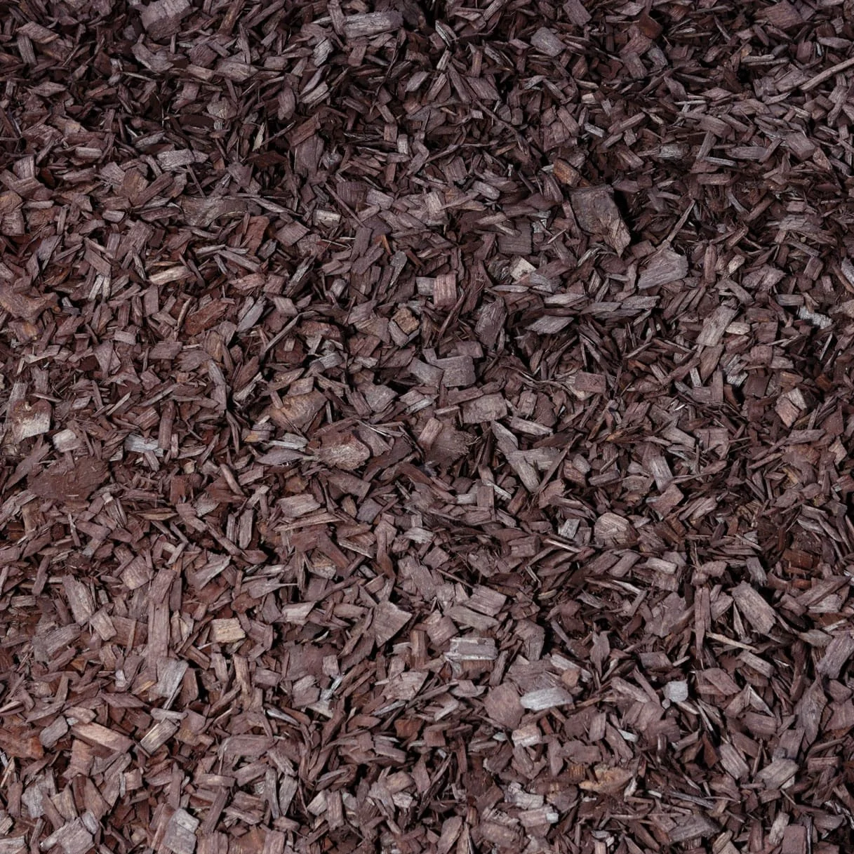 Close-up of reddish-brown decorative wood chips or mulch.