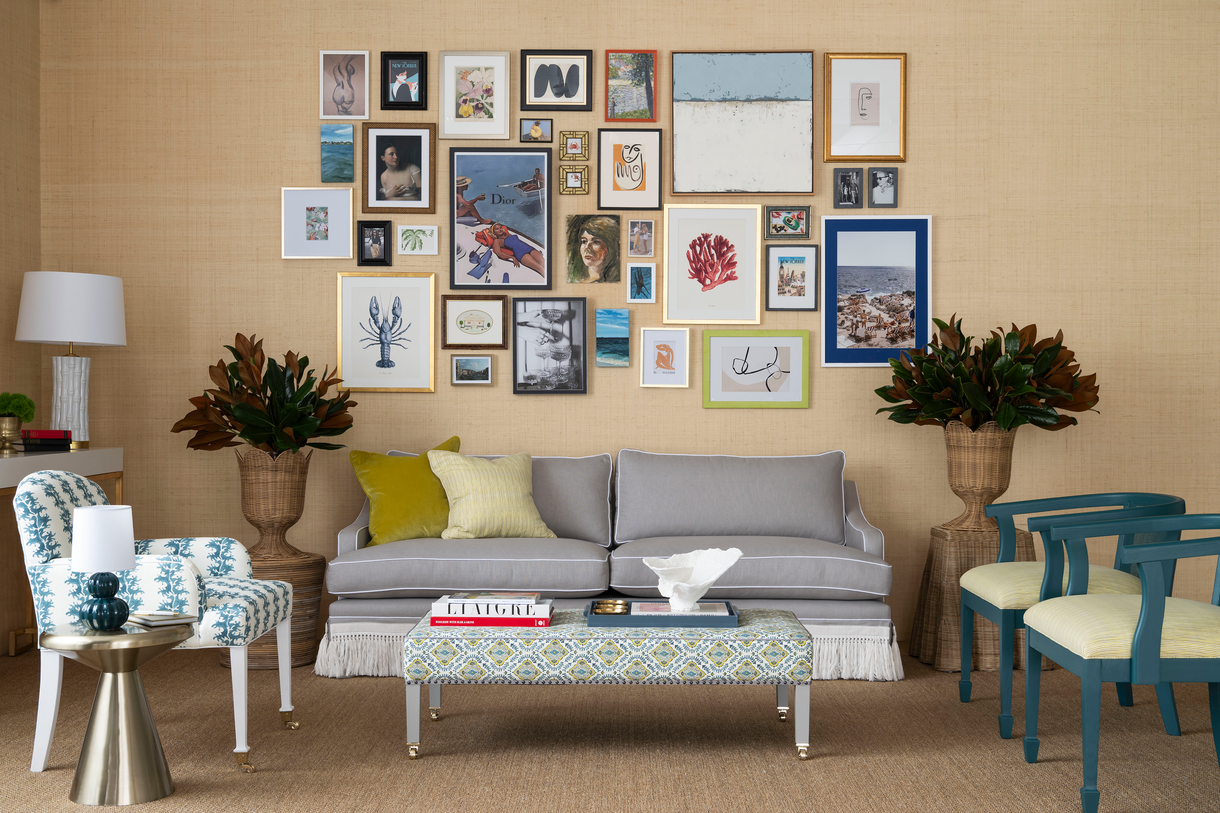 Throsby Sofa by Diane Bergeron for Arthur G in grey upholstery with white piping and a fringed skirt, styled beneath a gallery wall.