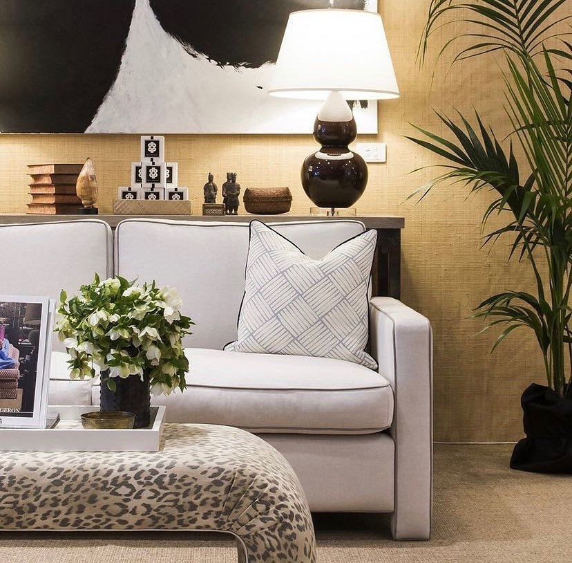 Minty Sofa by Diane Bergeron for Arthur G styled in a layered interior with neutral upholstery, contrast piping, patterned cushion, lamps and greenery.
