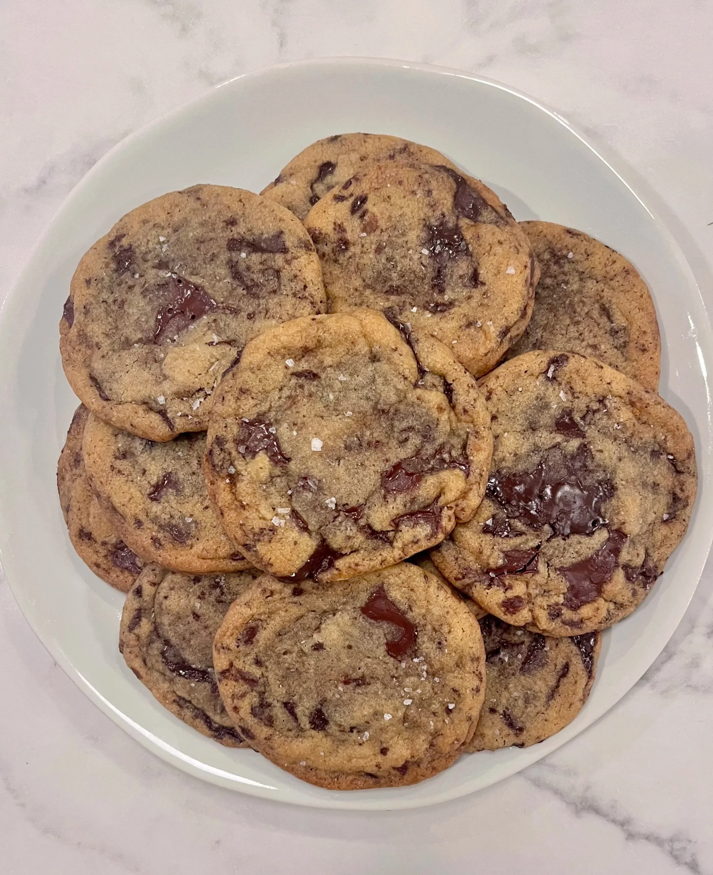 Plate of chocolate chip cookies on a white dish.