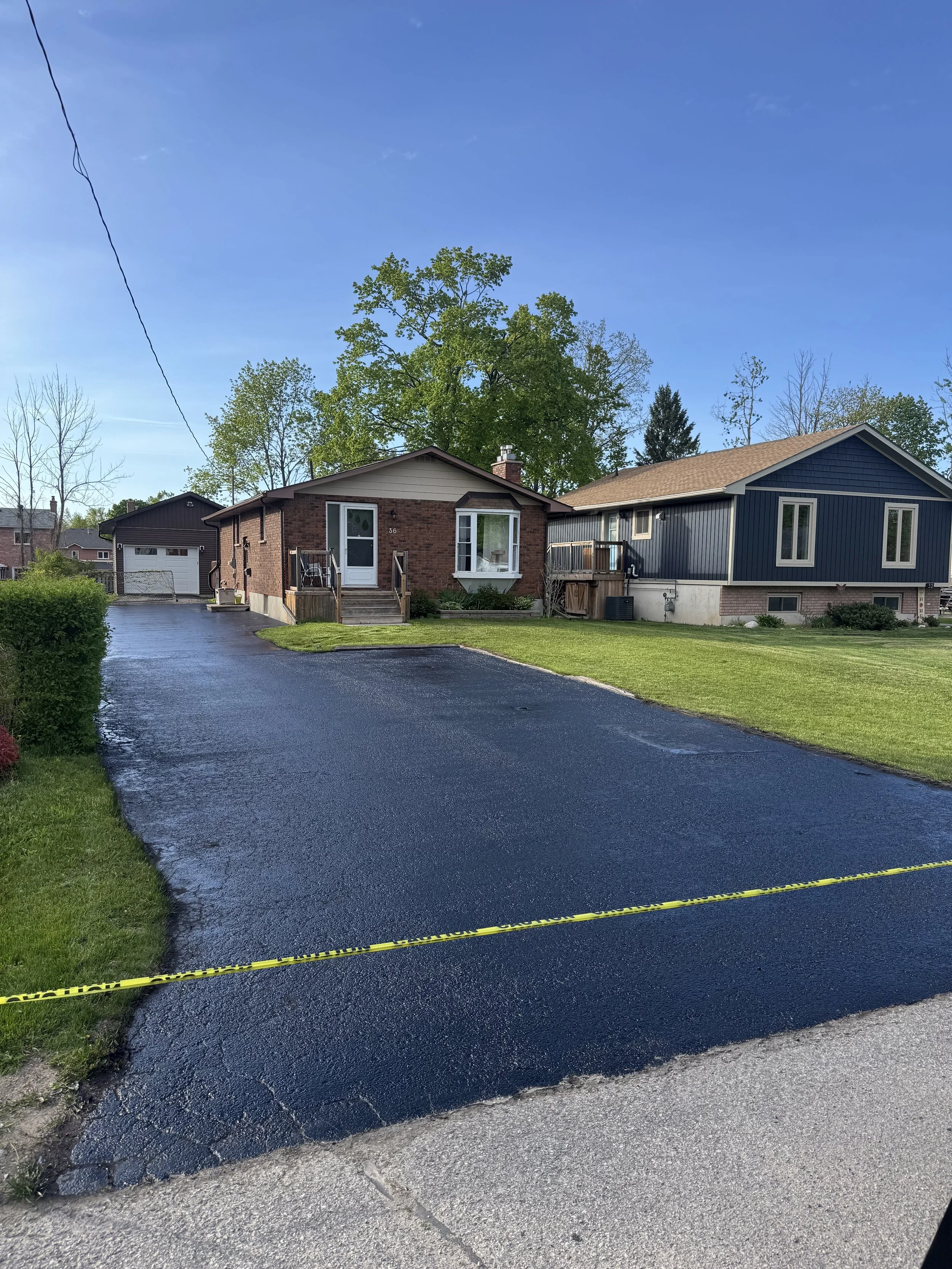 Freshly sealed residential asphalt driveway completed by Silverline Property Maintenance in Orillia, Ontario