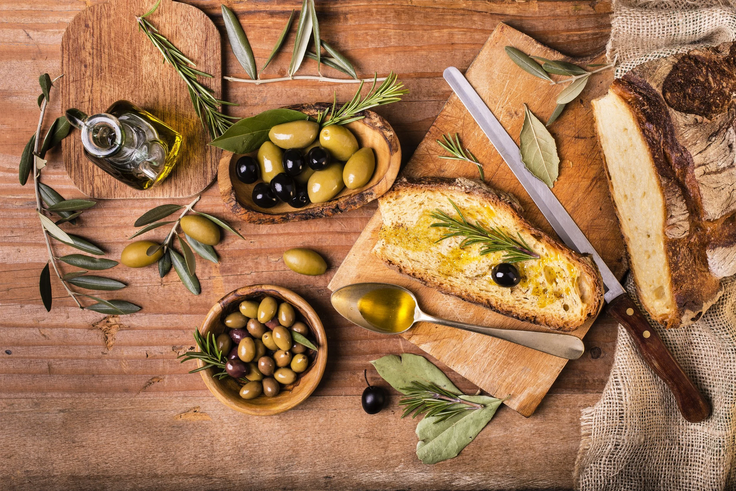 Small plates with olives, olive oil, and fresh baked bread