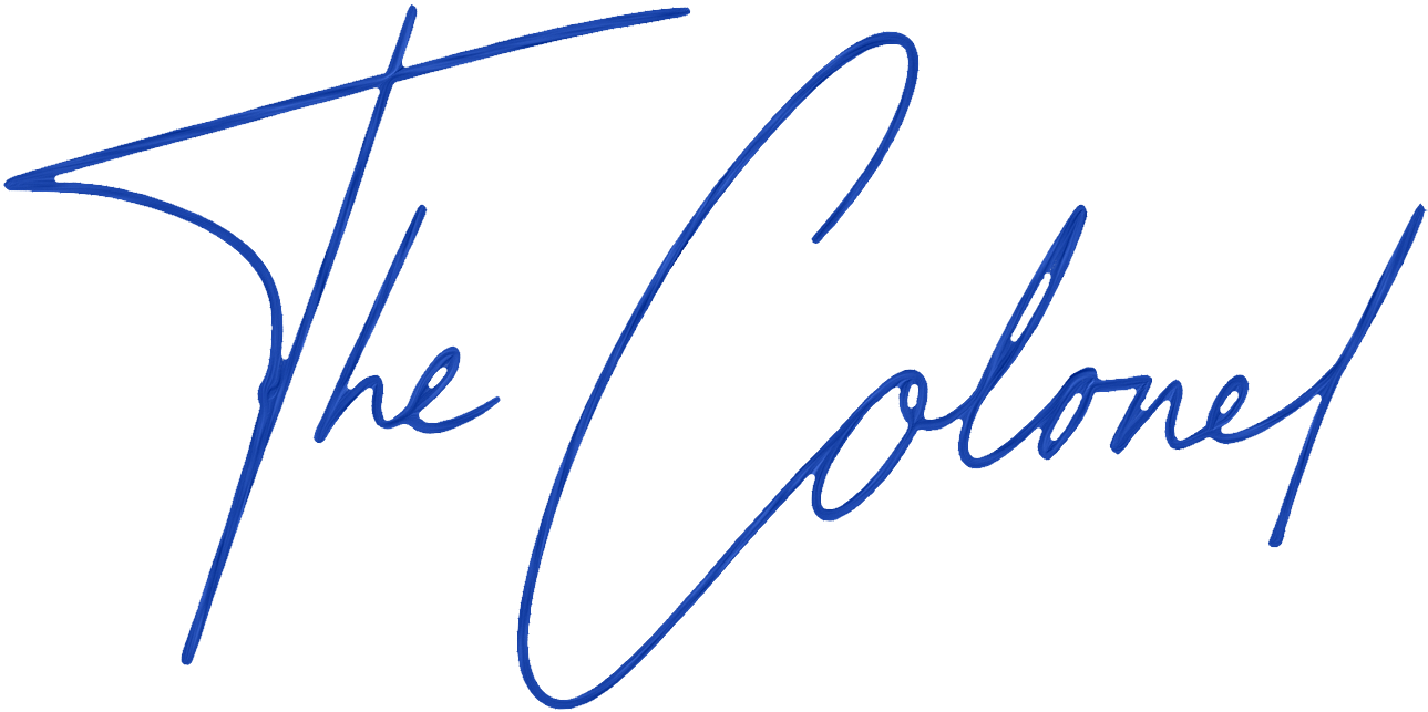 Signature of 'The Colonel' in blue.