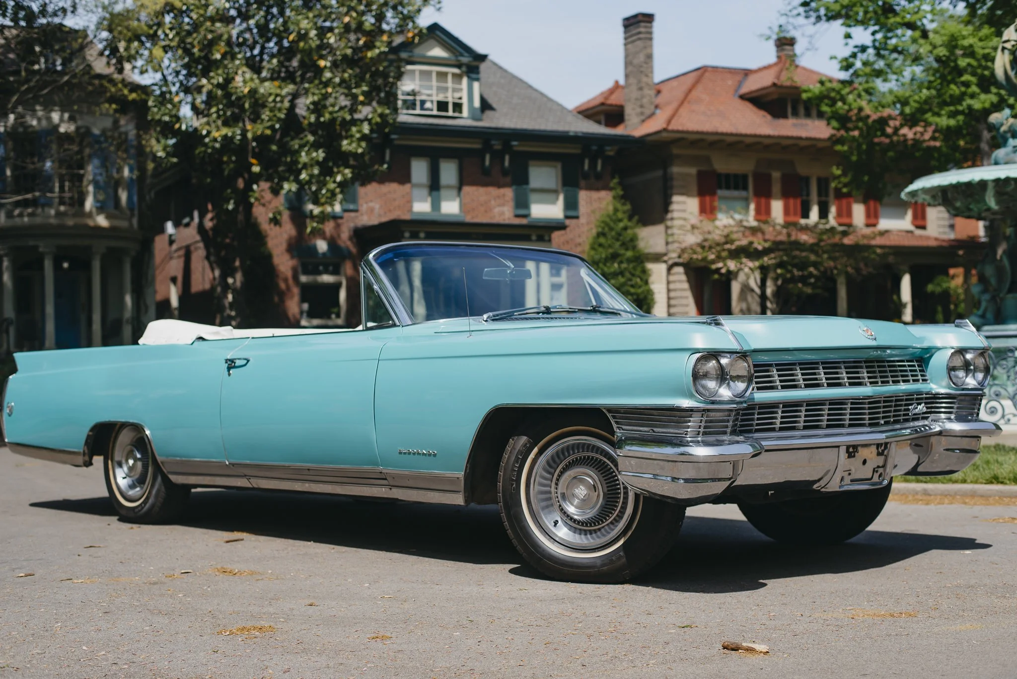 Charlene, a 1964 Cadillac Eldorado convertible, parked on St. James Court in Louisville, KY in front of Victorian houses with trees and a fountain.