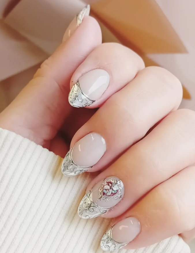 Close-up of a hand with manicured nails featuring white and clear design, with floral accents on some nails.