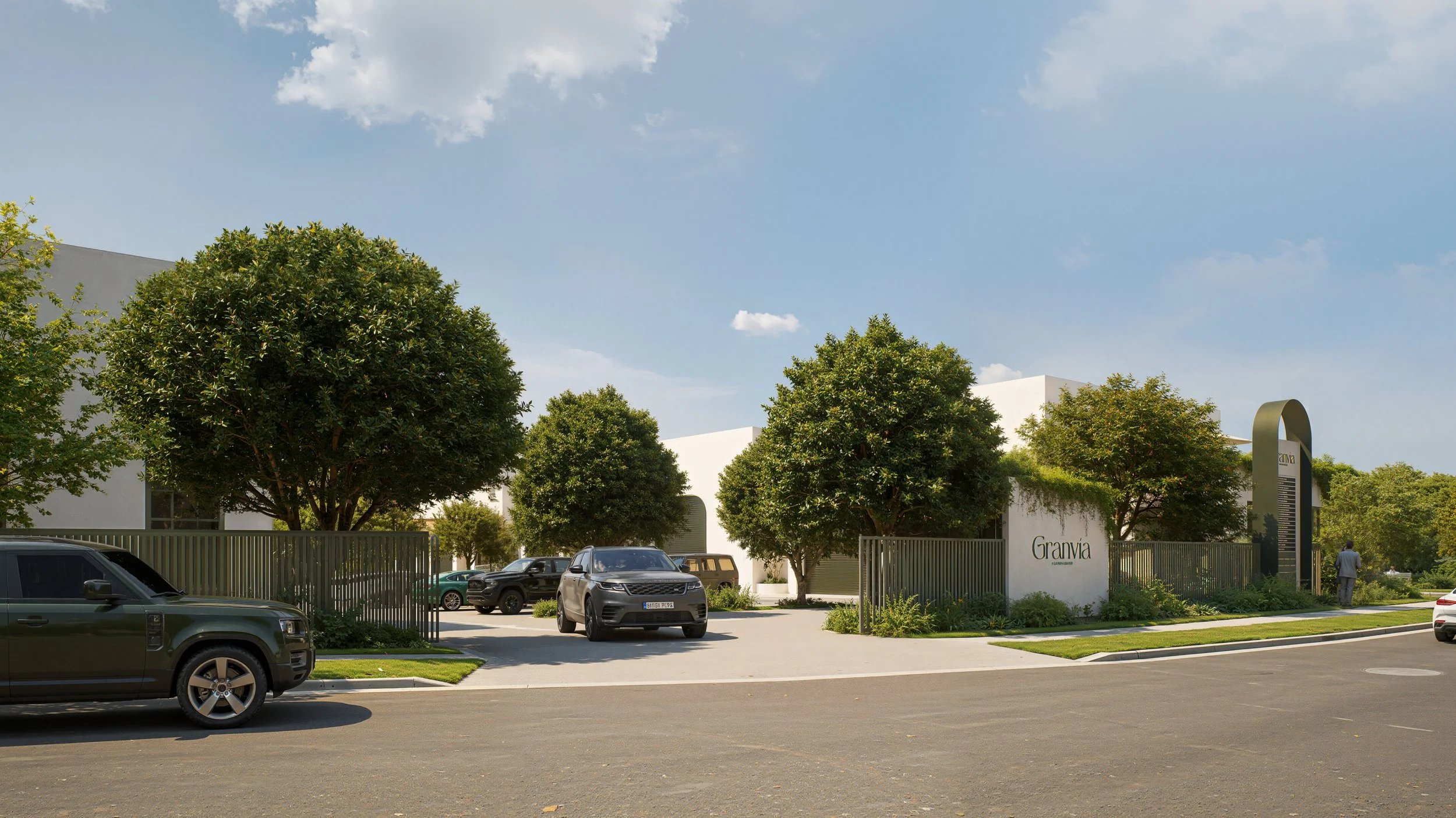 Exterior view of a modern building named 'Granvia' with trees, parked cars, and a clear sky.