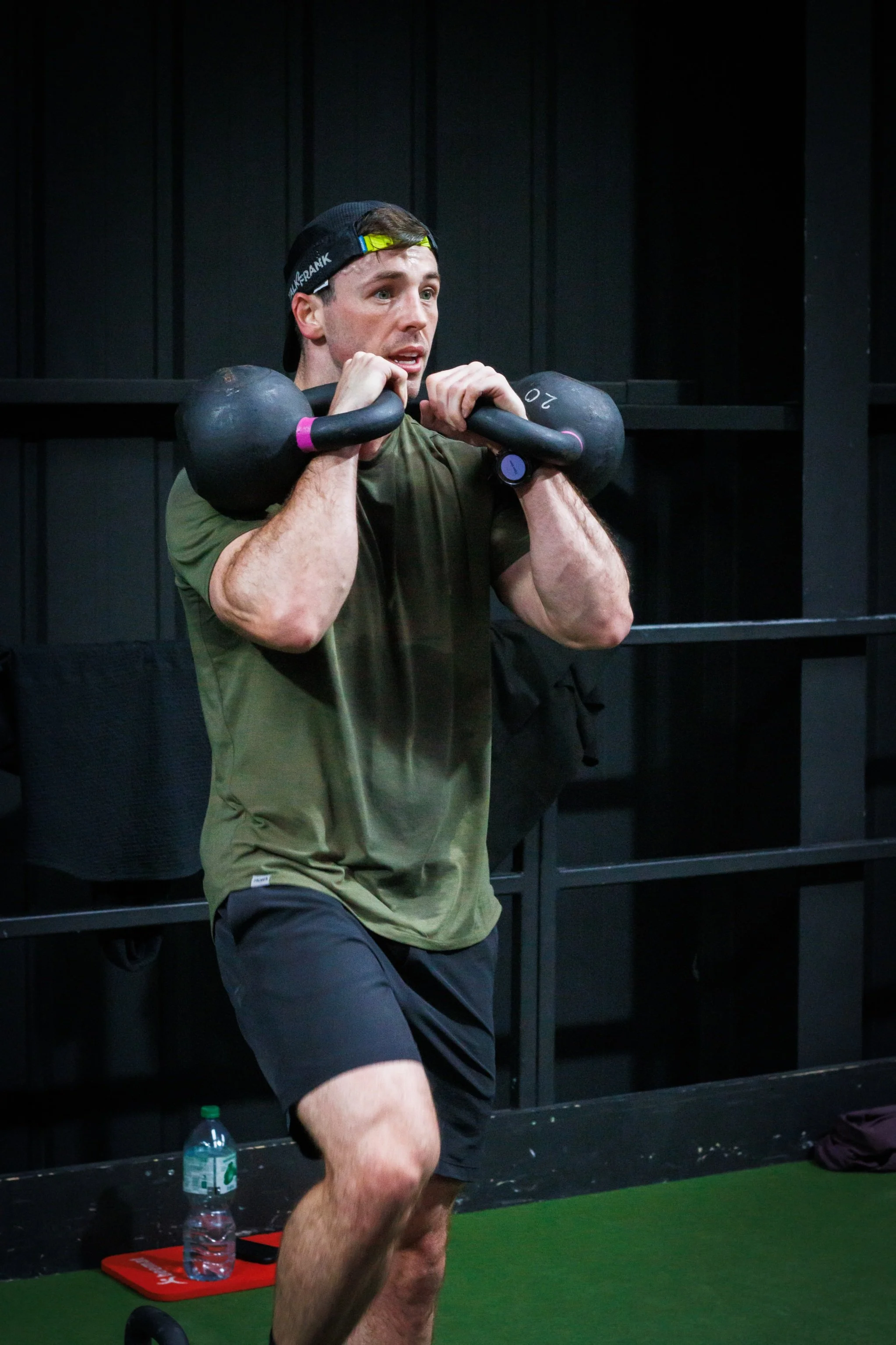 Personal trainer demonstrating a kettlebell front rack exercise in a Liverpool gym