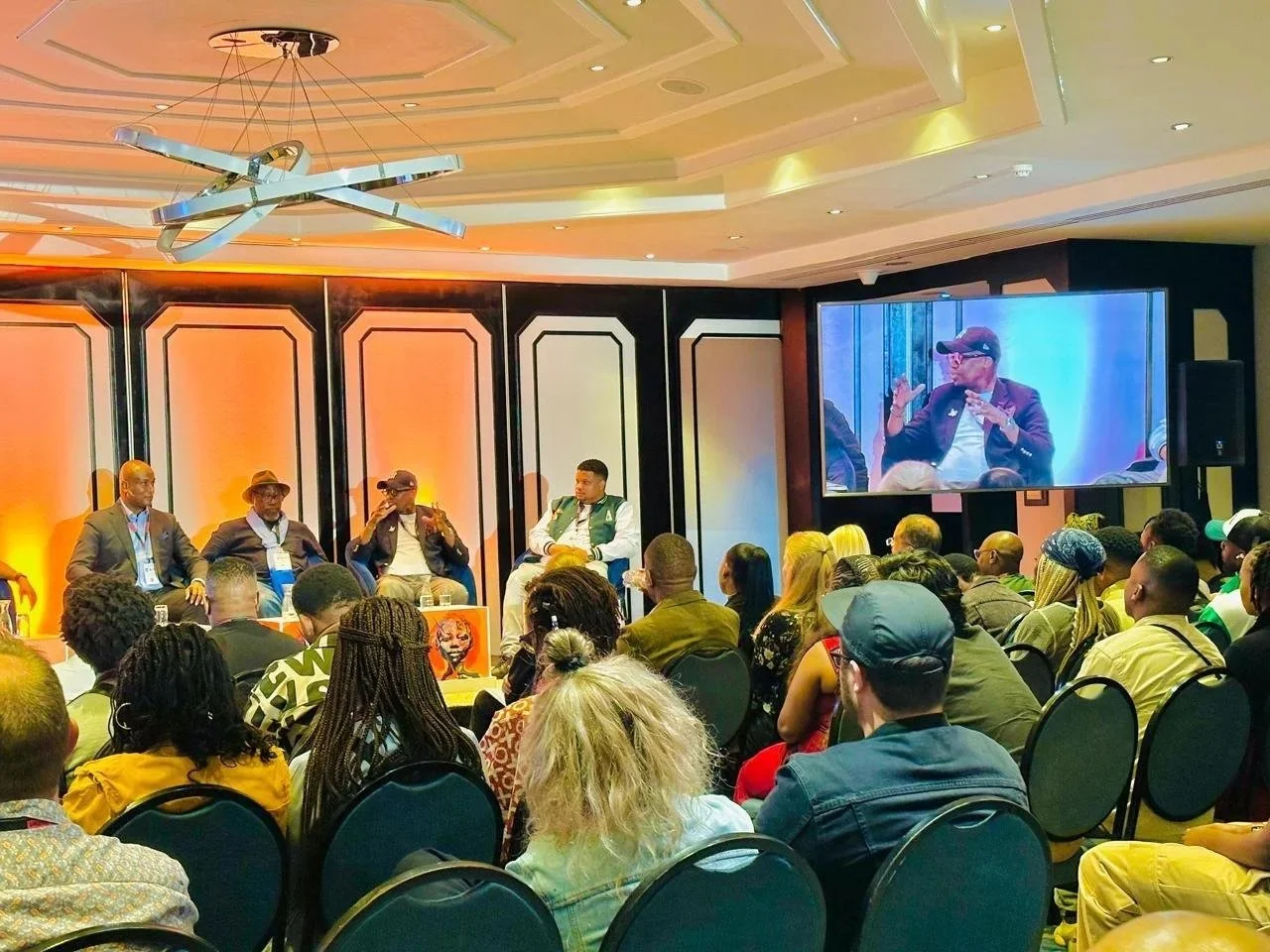 Monde Twala speaking on a panel at the Durban International Film Mart