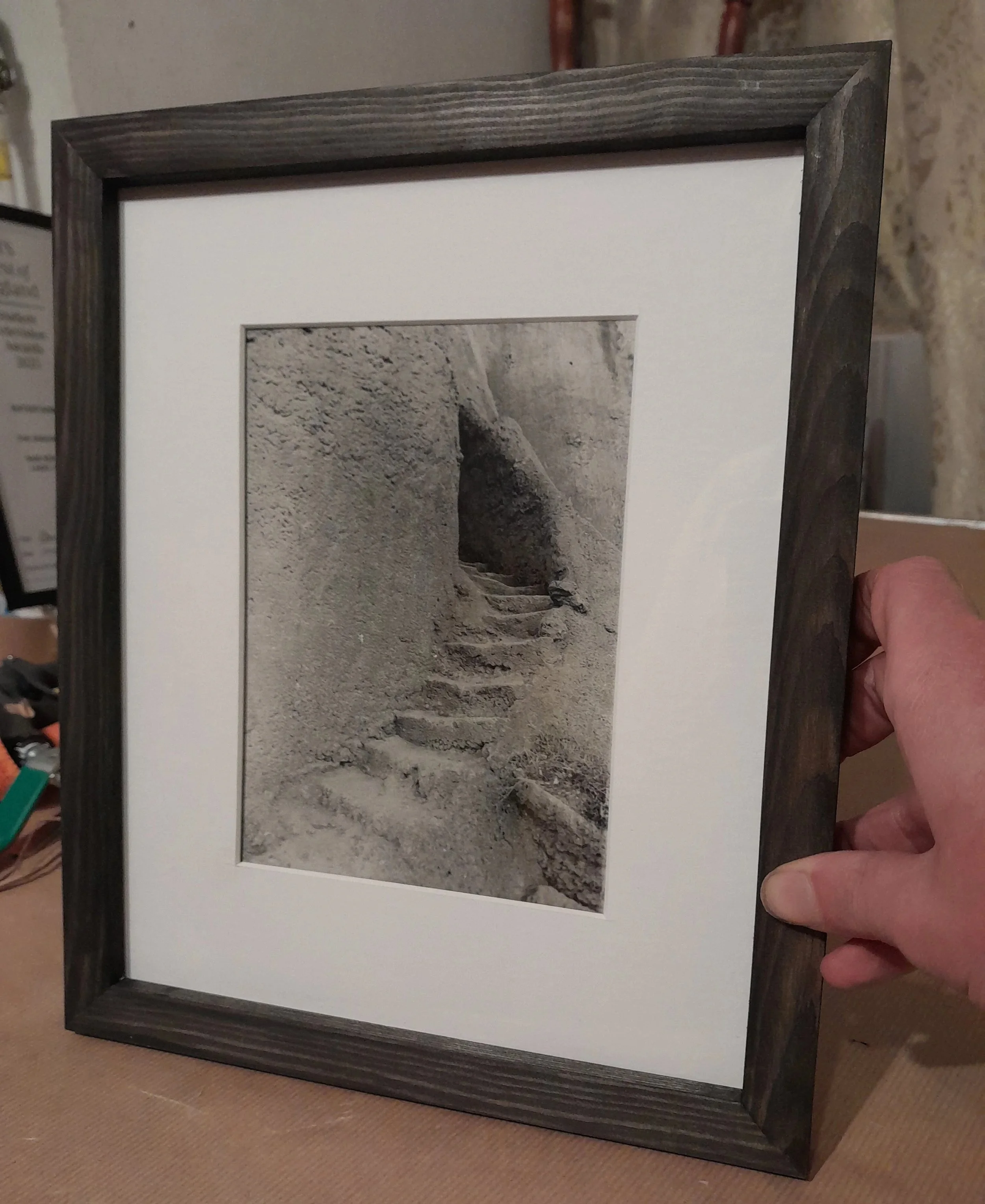 Black and white photograph of a stone stairway carved into a rocky hillside.