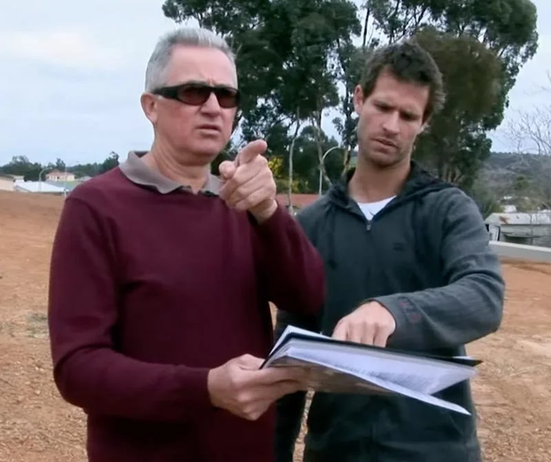 Dr Clint Hampson, Perth forensic expert & criminal lawyer, conducting research on the Scott Austic case, standing outdoors with another man looking at paperwork