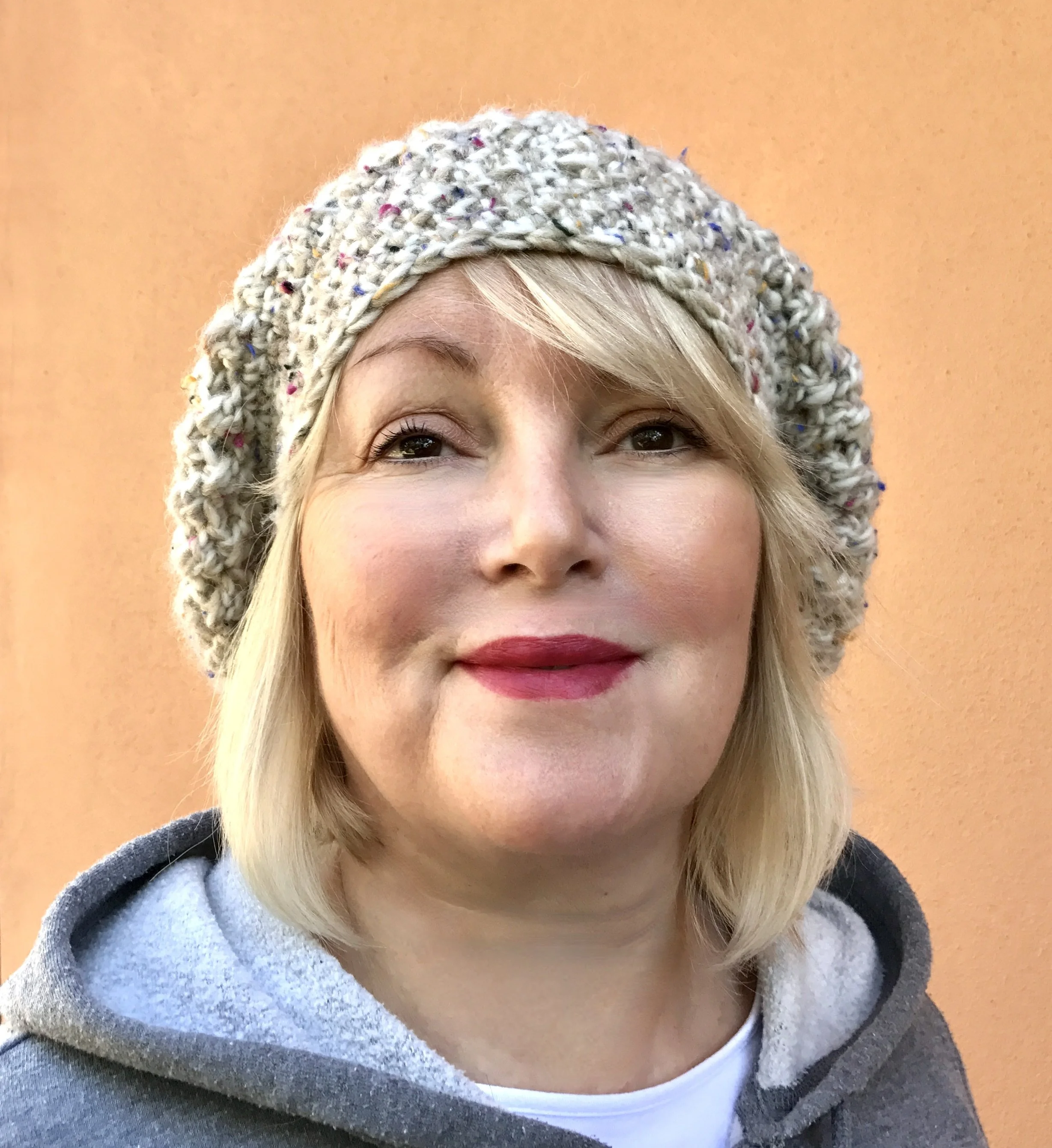 Tracy at Holy Moly Crochet wearing a hand made crocheted hat.