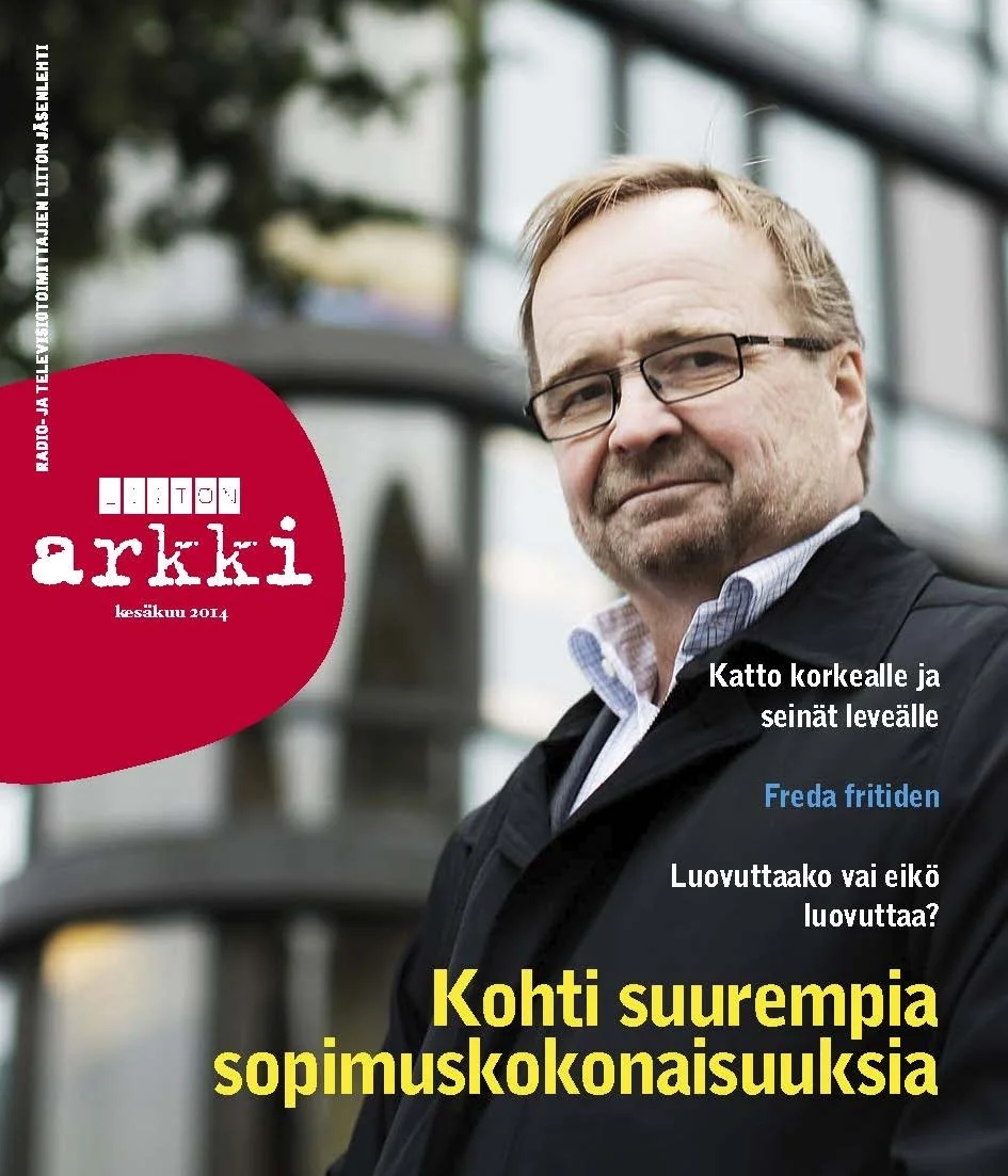 "Liiton Arkki" magazine cover with a man wearing glasses and a jacket, standing outdoors near a modern building with glass windows.