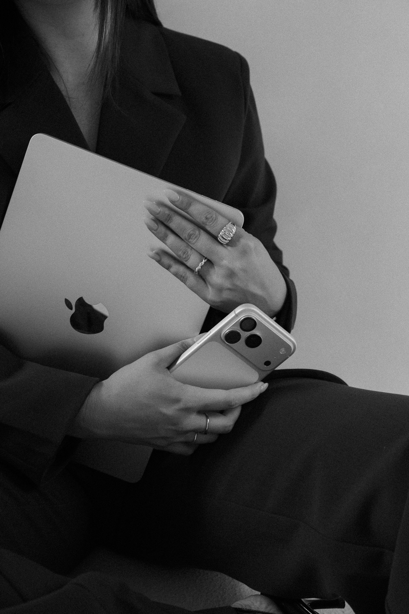 Anna holding a laptop and iphone