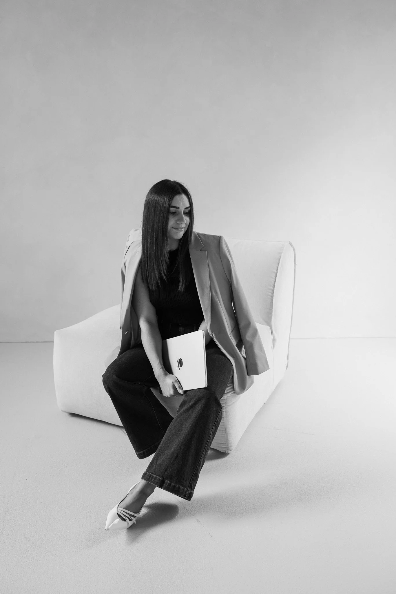 Graphic designer with a laptop sitting on a chair, Sunshine Coast.