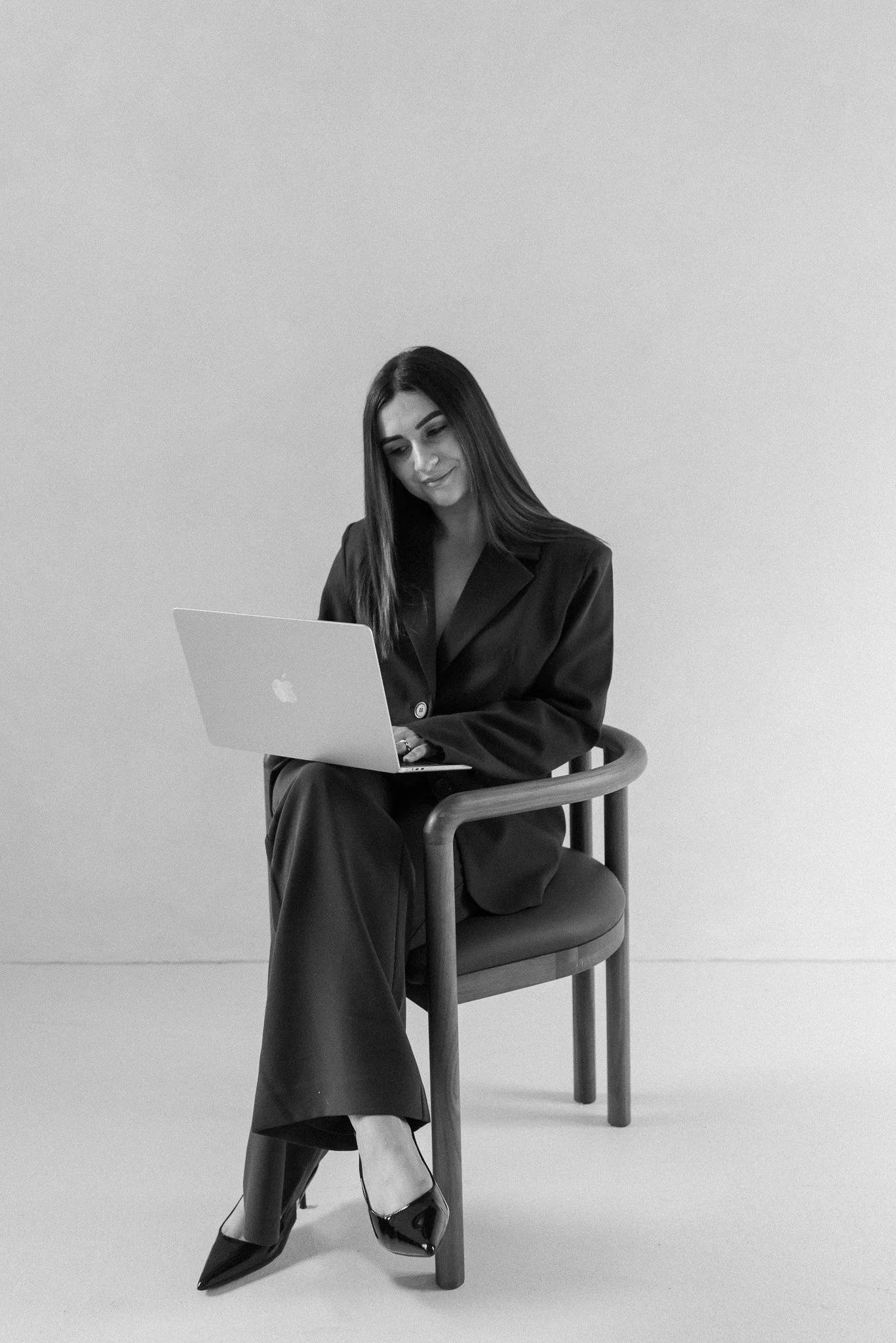 Anna sitting down with a laptop on lap