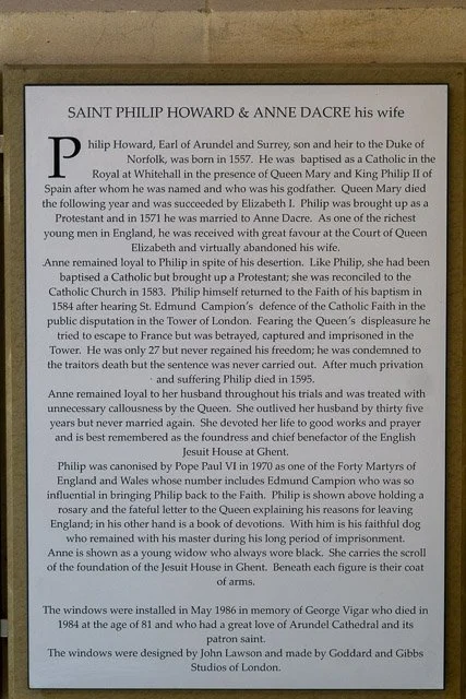Historical plaque dedicated to Saint Philip Howard and Anne Dacre, describing Philip Howard's life, loyalty to the Catholic Church, and his canonization, including details about his imprisonment and beatification.