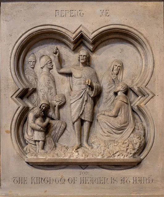 Relief sculpture depicting Jesus Christ with children and others, centered in a heart-shaped frame, with the inscription 'REPEATING YE' at top and 'FOR THE KINGDOM OF HEAVEN IS HIS' at bottom.