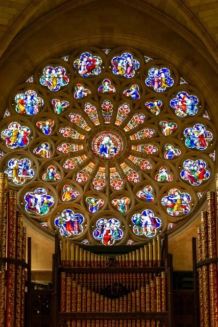 Colorful stained glass rose window in a cathedral.