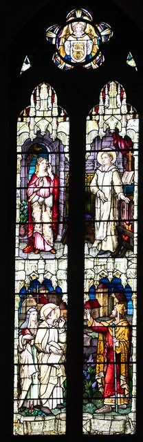 Stained glass window depicting four biblical scenes with religious figures, including Jesus and saints, in Gothic style.