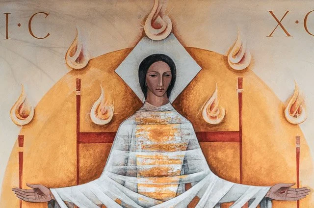 A religious painting of a woman with dark hair, wearing a striped white and gold robe, with her arms outstretched. Behind her, a golden semicircle and flames are depicted, with the letters I:C and X:C in the top corners.