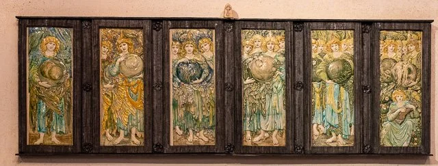 A row of six religious icon paintings of saintly women in ornate clothing, framed with a dark wooden border.