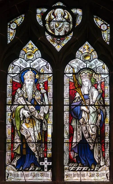 Stained glass window depicting King David and King Solomon seated with crowns, robes, and scepters, with religious symbols and colorful details.