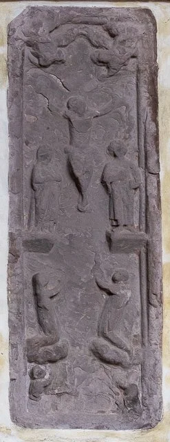 Ancient carved stone slab with relief depicting religious or mythological figures and scenes.