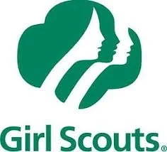 Logo of Girl Scouts featuring three stylized faces of girls with flowing hair in a green silhouette