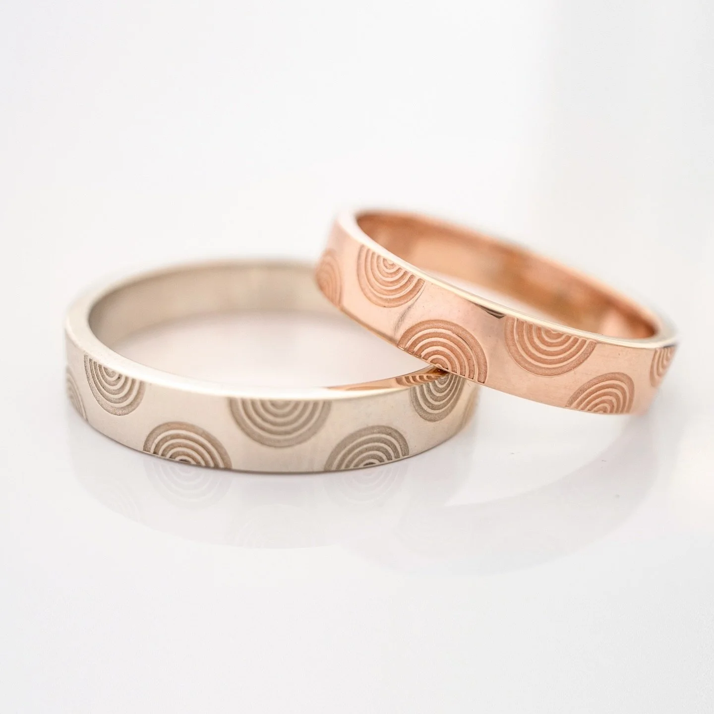 The pattern on this ring is from the unique geometric drawings of ancient Minoan pottery from the Bronze Age and represents the arches of the winds of the Cyclades islands, which the Minoans ruled from about 3000 to 1100 BC. 

What a perfect wedding 