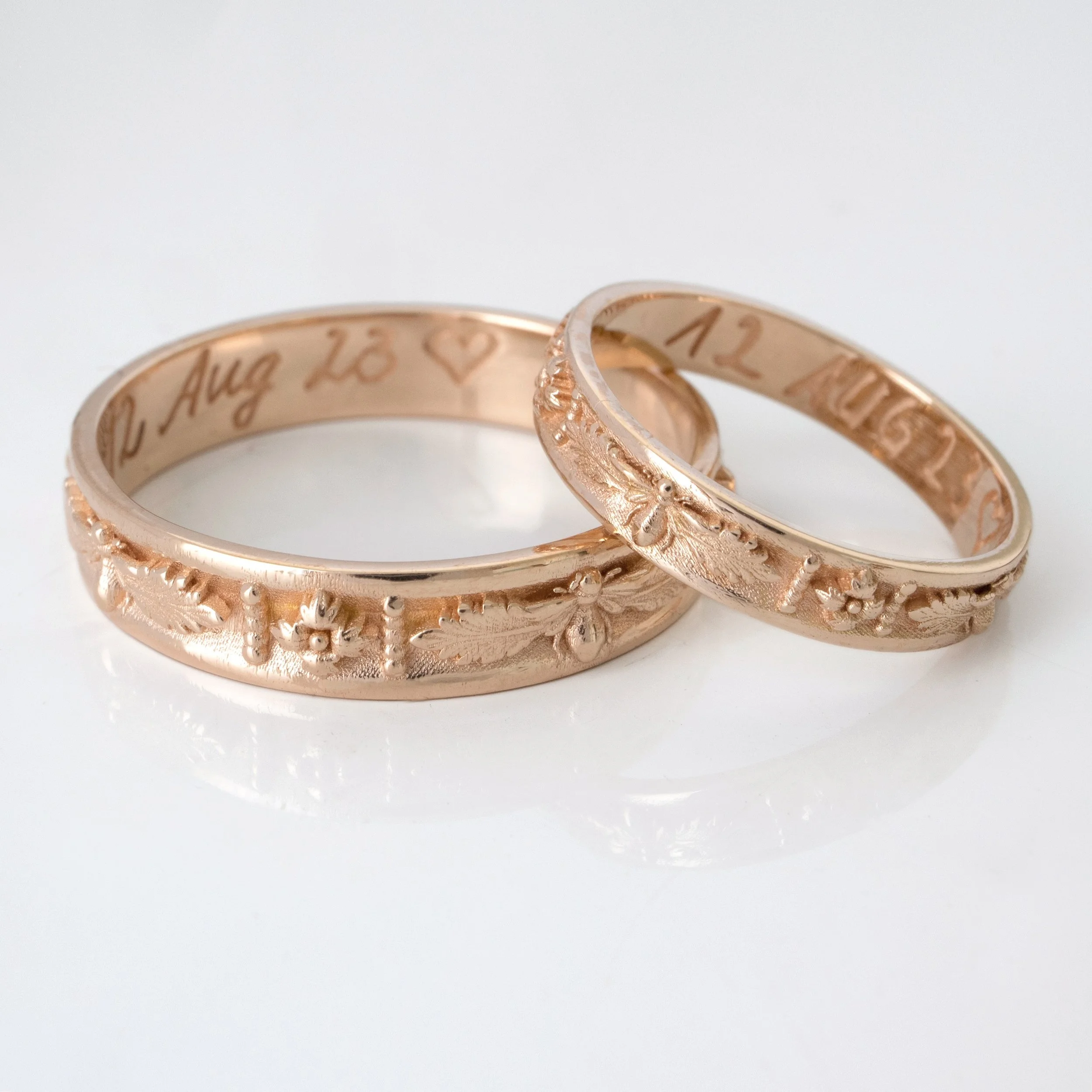 Bees and Flowers as a custom couple&rsquo;s band set with their own handwriting engraved on the inside. We specialize in custom wedding bands, contact us to create your heirloom engagement sets. 
✧
#emmakrafft #newnostalgia #customjewelry #beejewelry