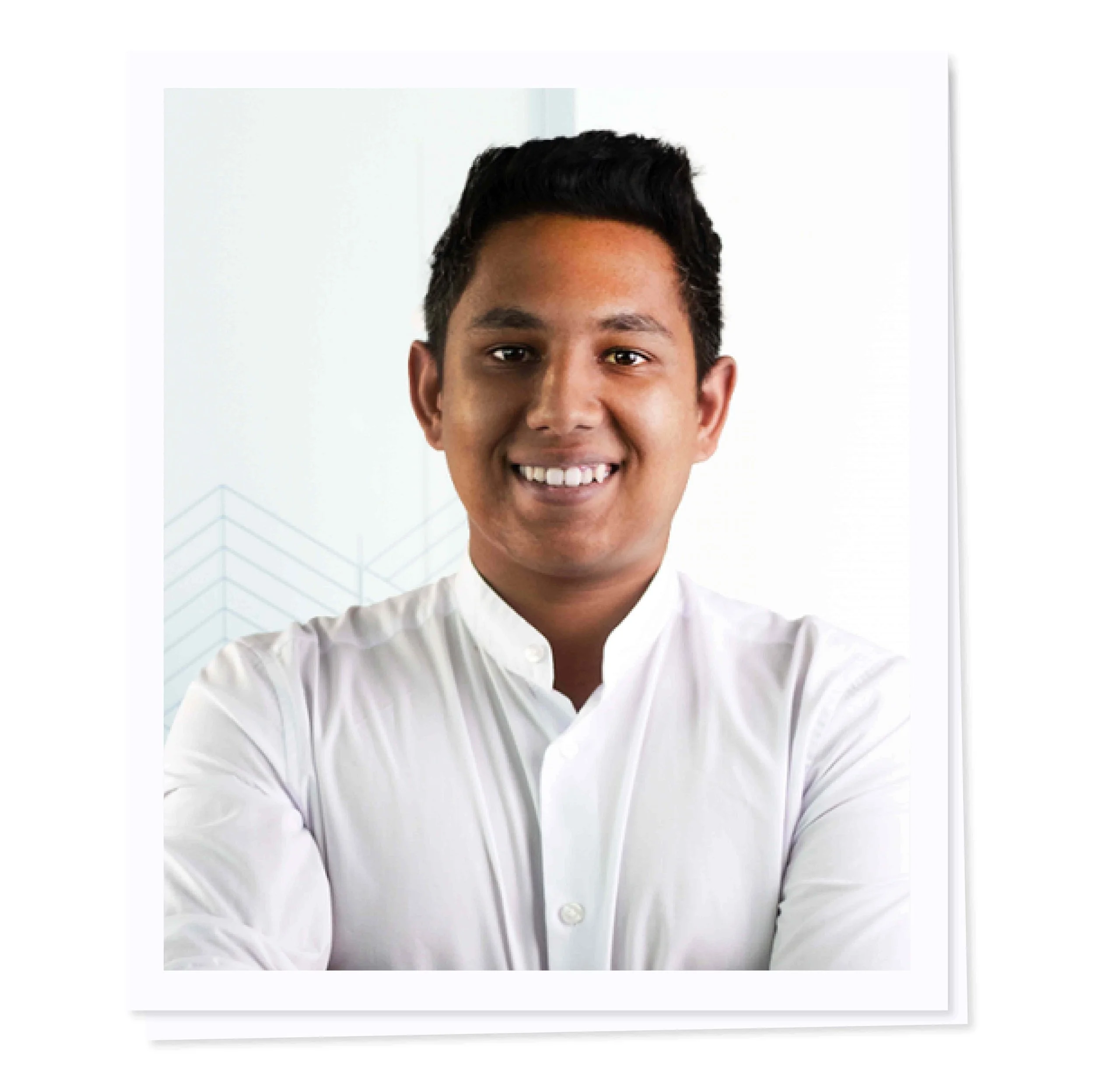 Smiling person in a white shirt against a light background with geometric design.