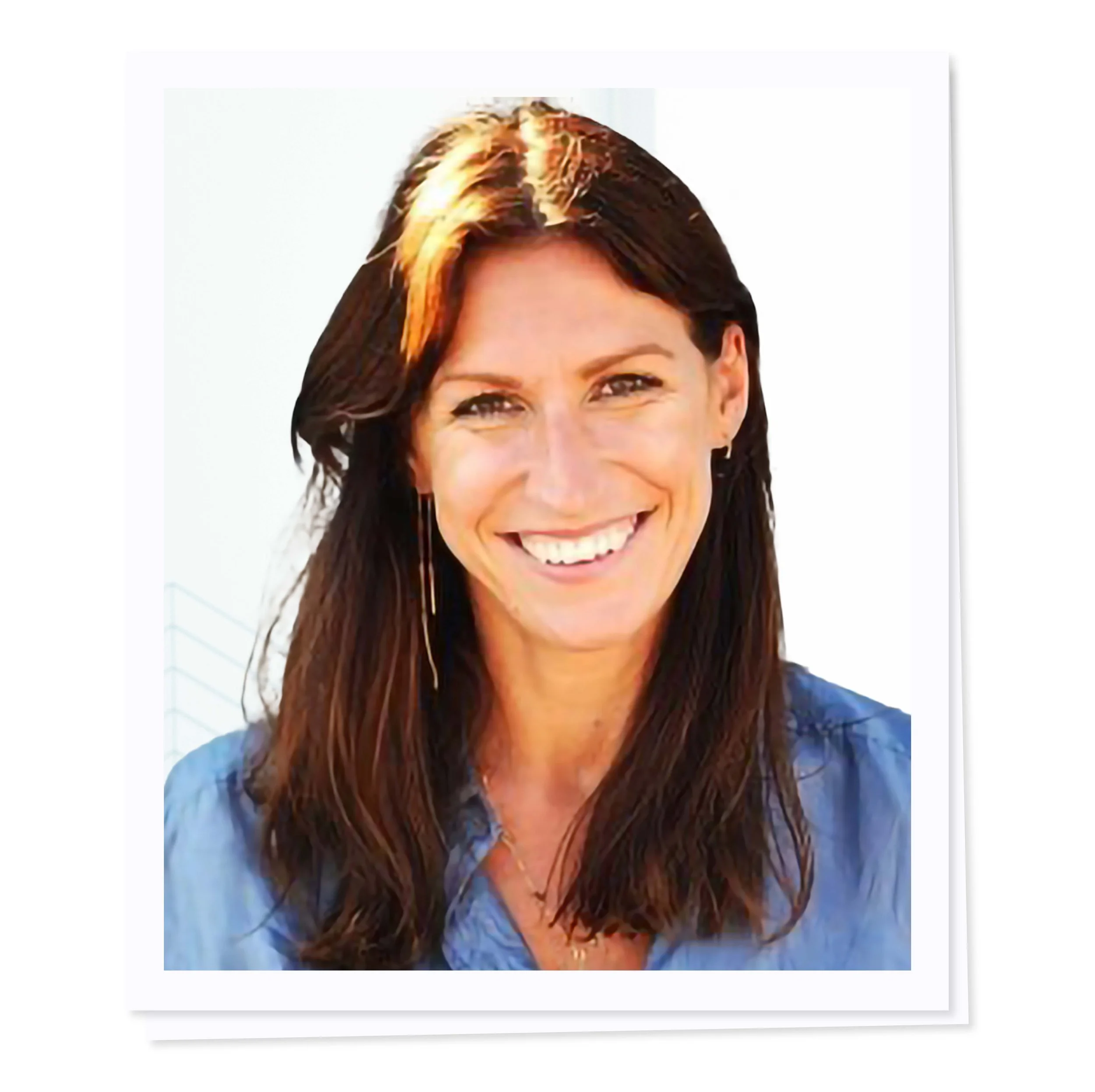 Smiling woman wearing a blue shirt with brown hair, facing forward.