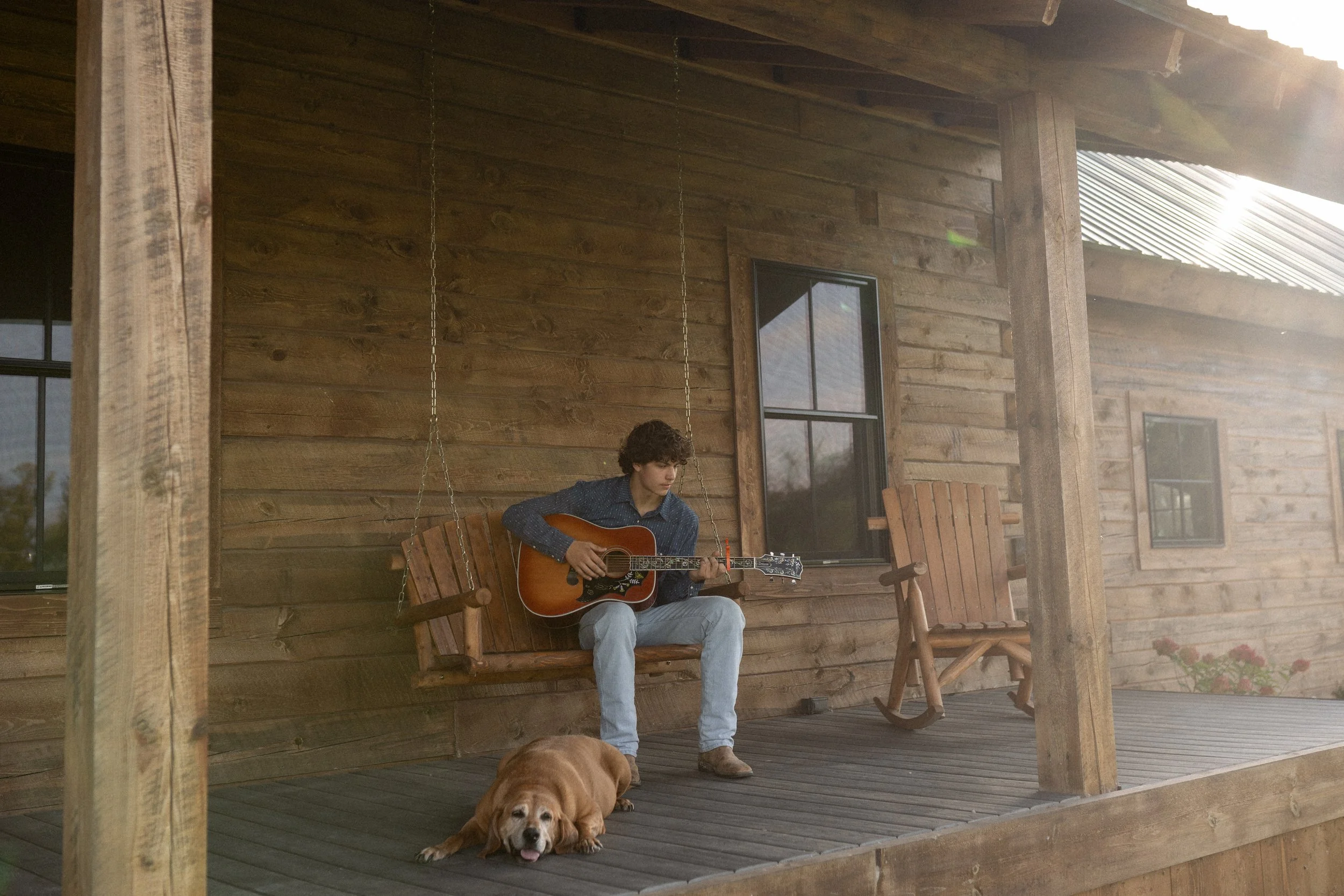 Fargo North Dakota senior portrait session with acoustic guitar on rustic farmhouse porch photographed by Aesthete Pix
